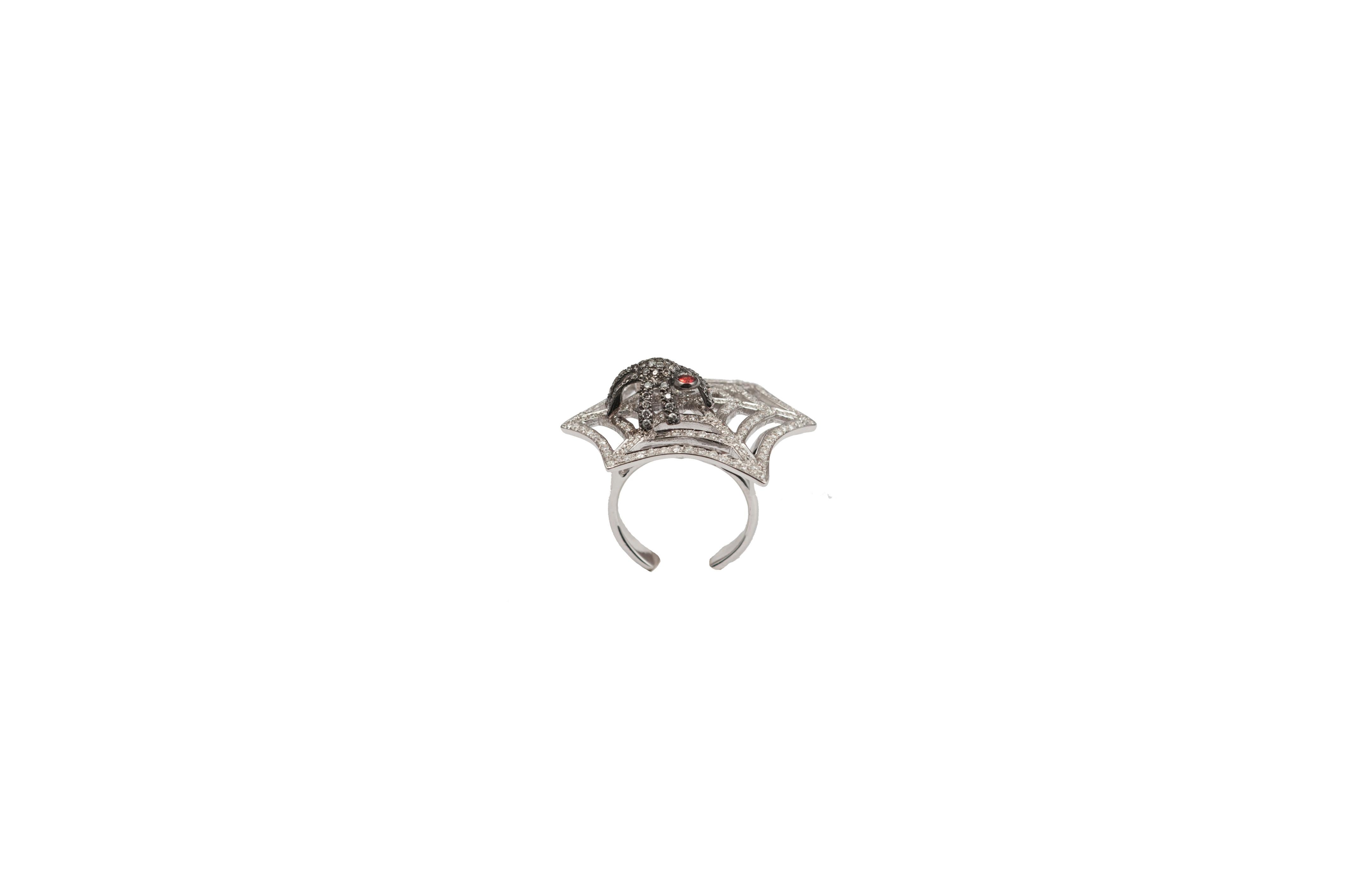 Gold web ring pavè diamonds with spider.

Composition: 
Gold 10,35 gr (9K)
157 diamonds 0,95 ct
54 grey diamond 0,20 ct
1 red sapphire 0,06 ct 

Size is adjustable from 6 US to 7 1/4 US ( italian size from 12 to 15)
Other sizes on demand, working
