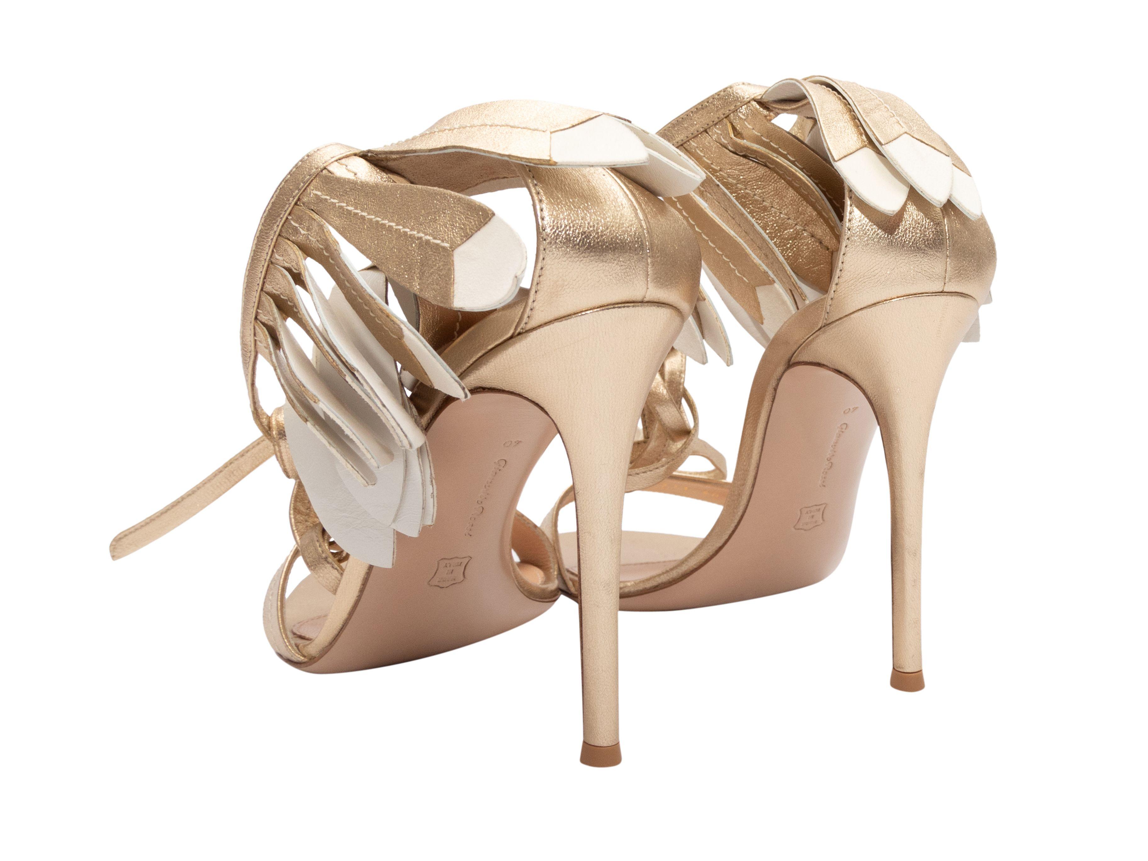 Gold and white leather fringe heeled sandals by Gianvito Rossi. Lace-up tie closures at ankles. 4.5