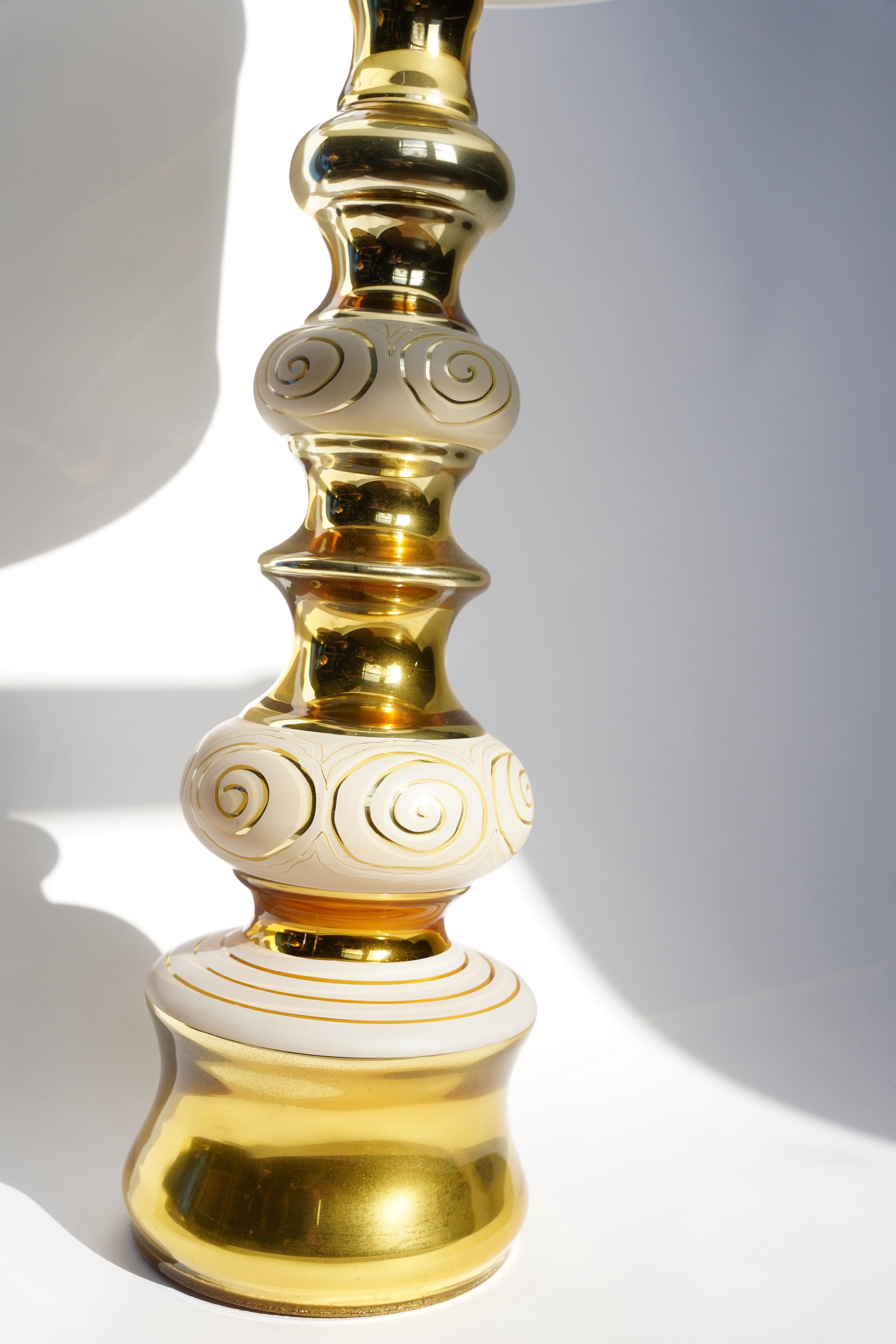Pair of gold glass with white etched pattern mercury glass Rosdala lamps, 1970 Sweden
Organically shaped tall standing glass that has white inscription to it on a large gold glass body.
Rewired for the US.

 