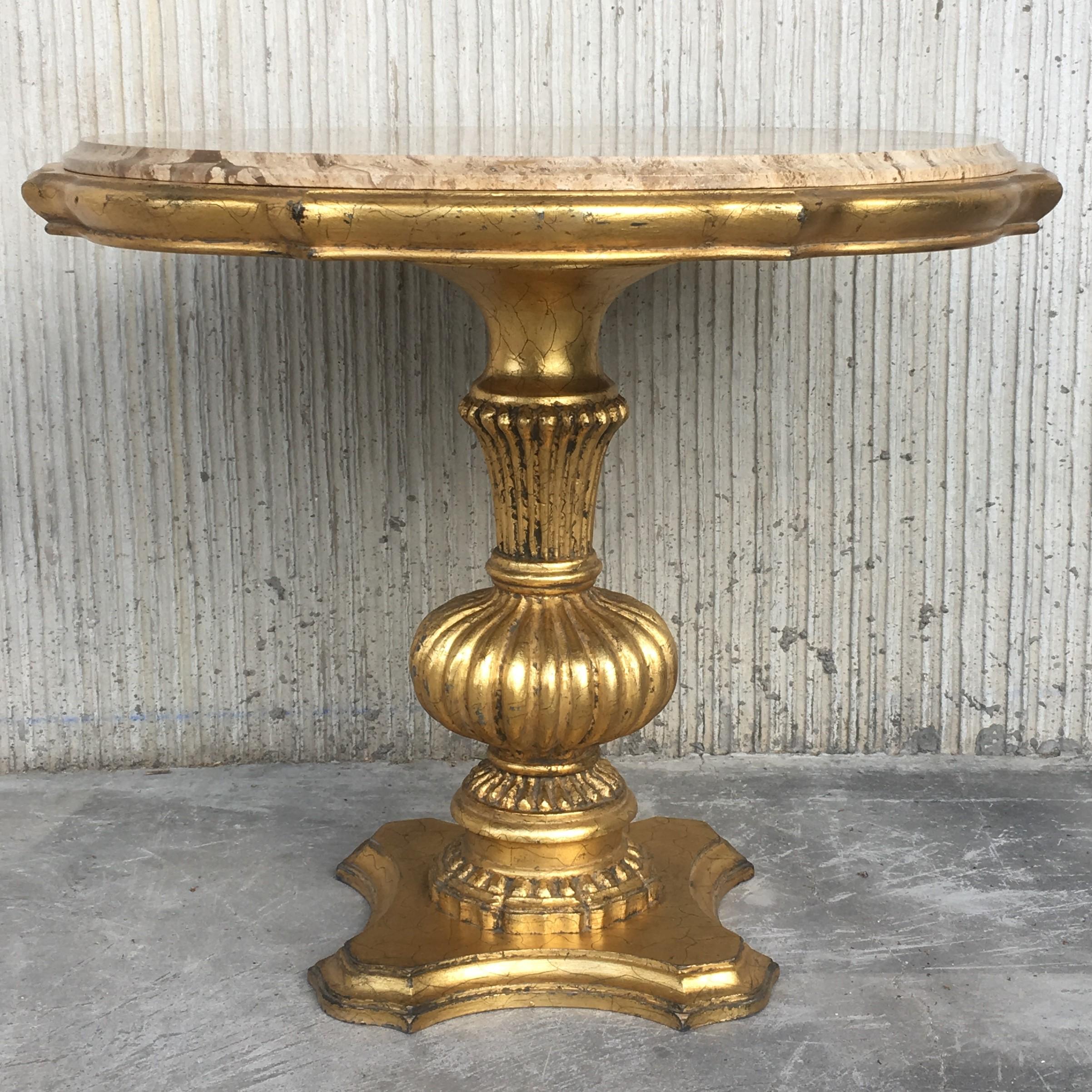 Giltwood Hollywood Regency Italian style marble-top low table. Item details solid wood pedestal bases, nicely carved details, distressed gold finish and round marble tops, circa early to mid-20th century, Spain.
Measurements: 23.52
