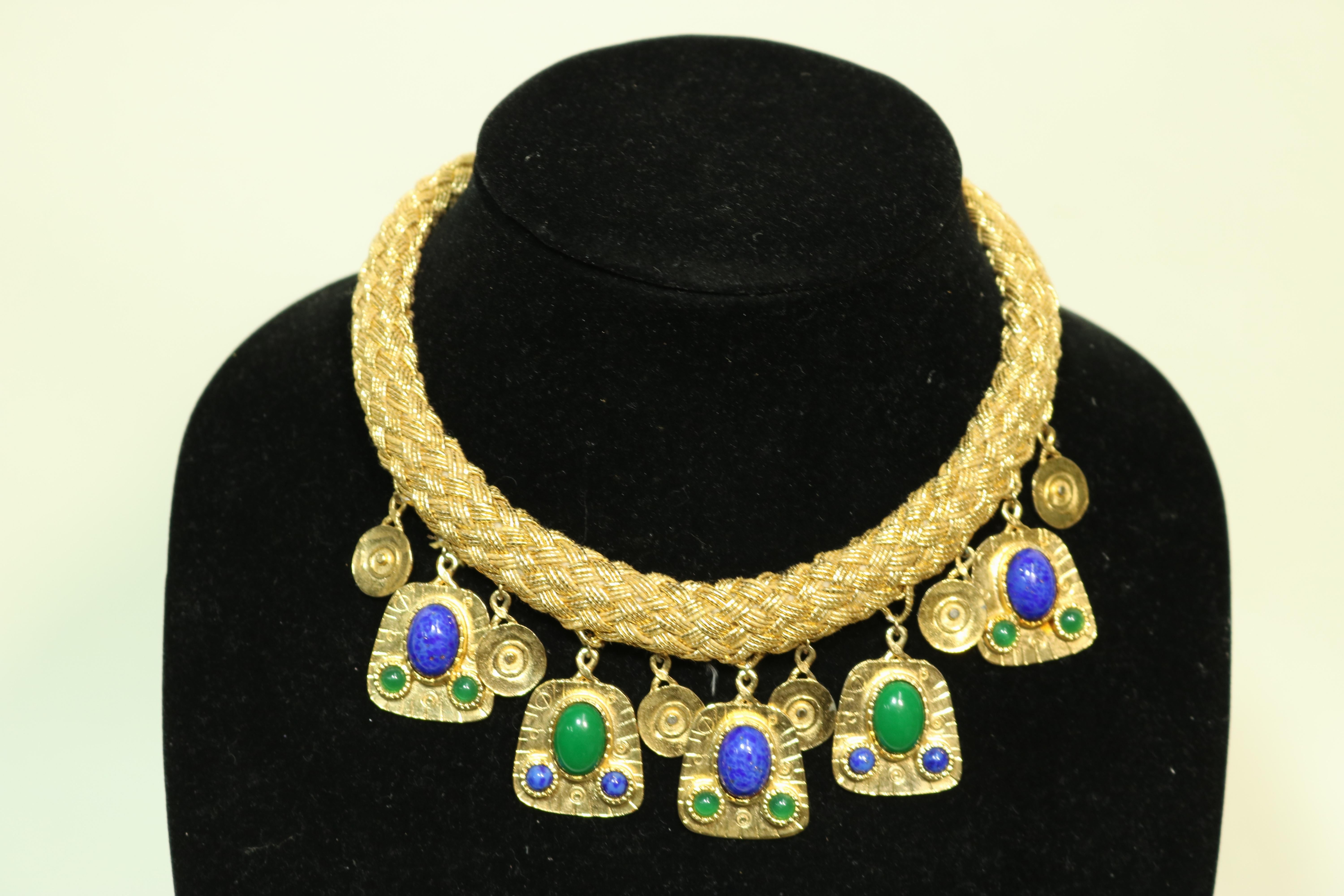 Stunning Egyptian Revival style woven gold thread collar necklace with heavy gold plate articulated drops laden with alternating faux malachite and authentic lapis cabochons and circular gold plate drops.

An exotic Cleopatra look makes for a