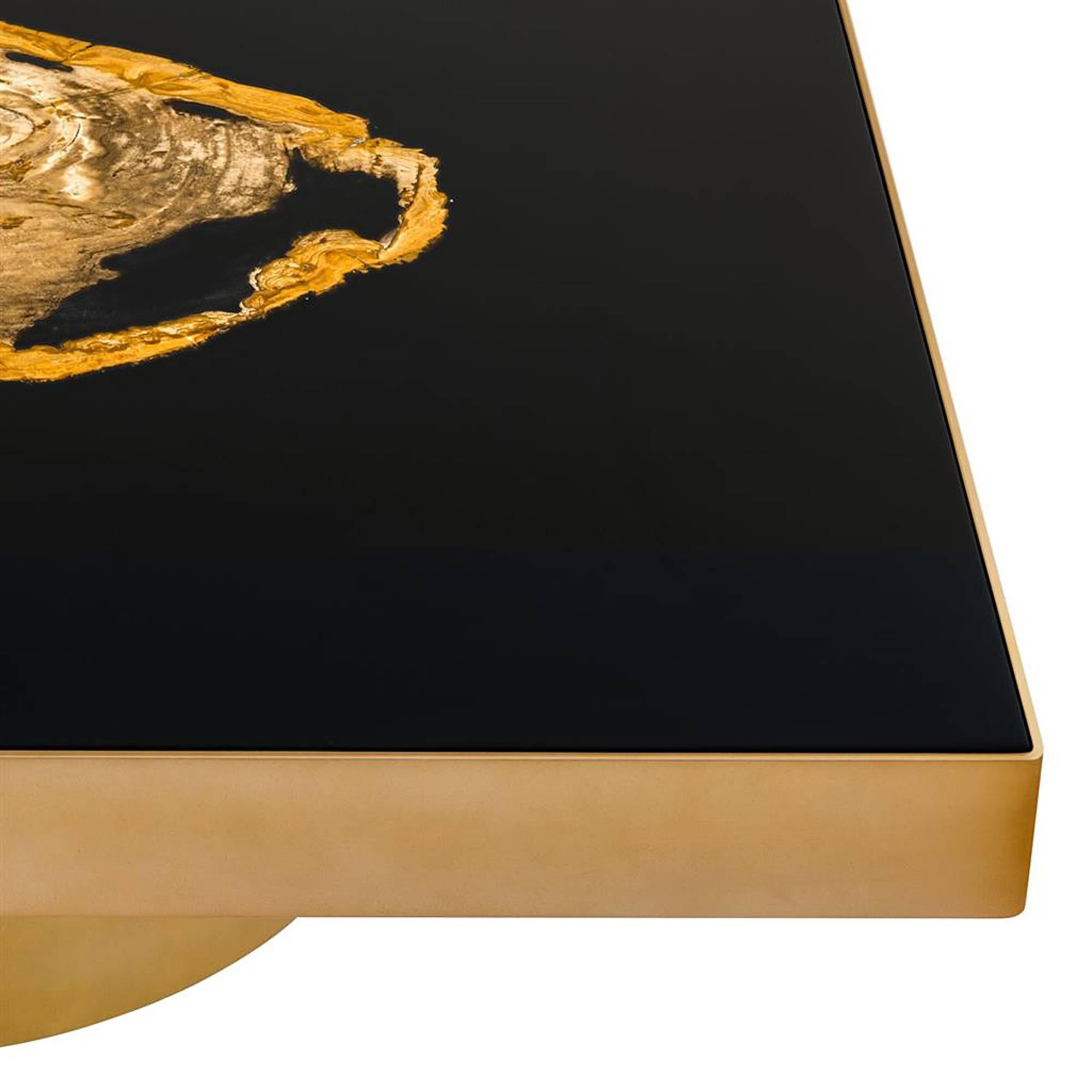 Coffee table golded petrified wood with brass structure in matte 
gold finish, handcrafted petrified wood and black lacquered top.