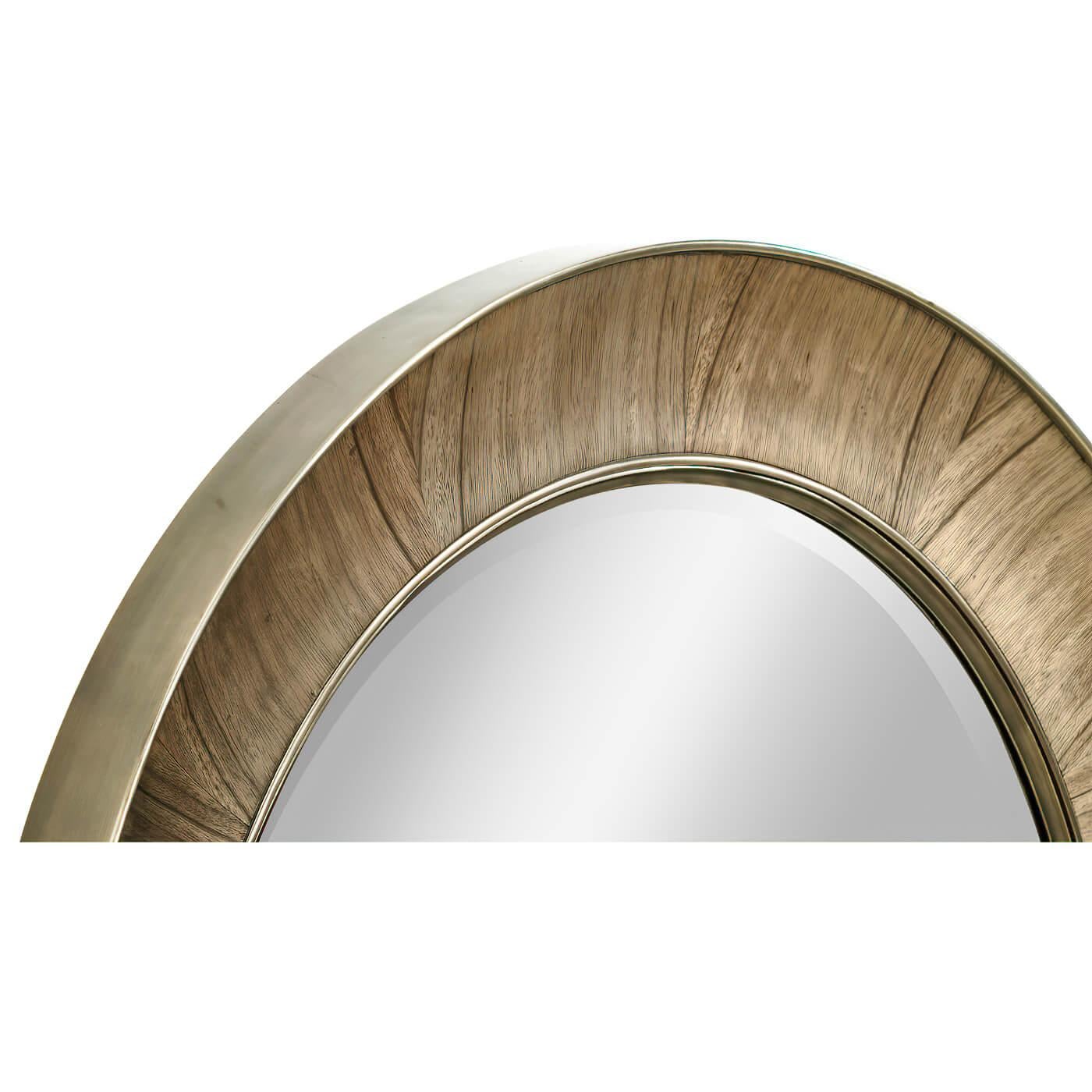 This golden amber veneered concave form round mirror with brass trim and a beveled mirror plate.

Dimensions: 38