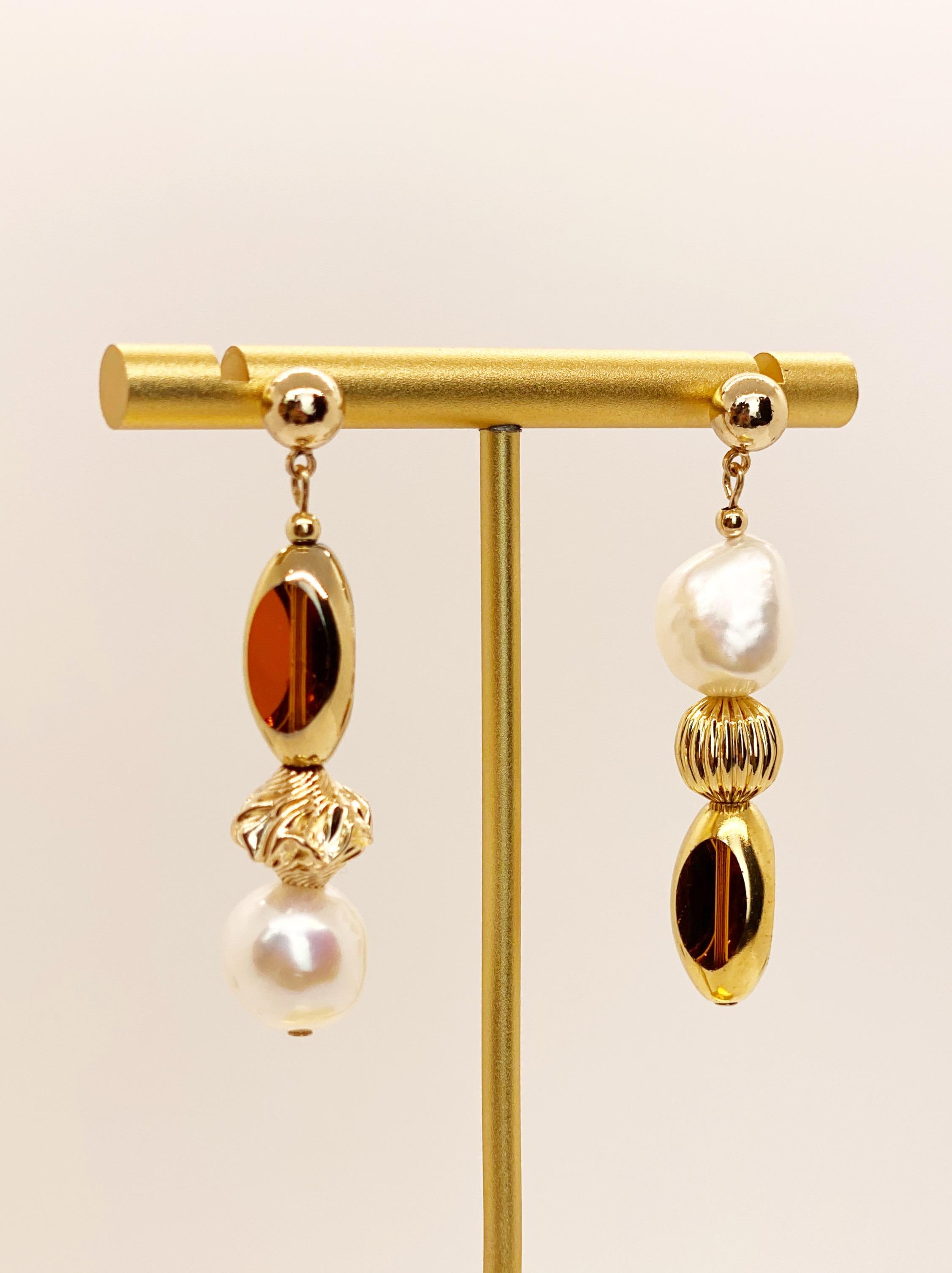 Golden Amber colored vintage German window glass beads edged with 24K gold, freshwater pearls, gold filled textured beads on a 14K gold filled earring stud. In some angles depending on the way the light shines through the window beads it may look