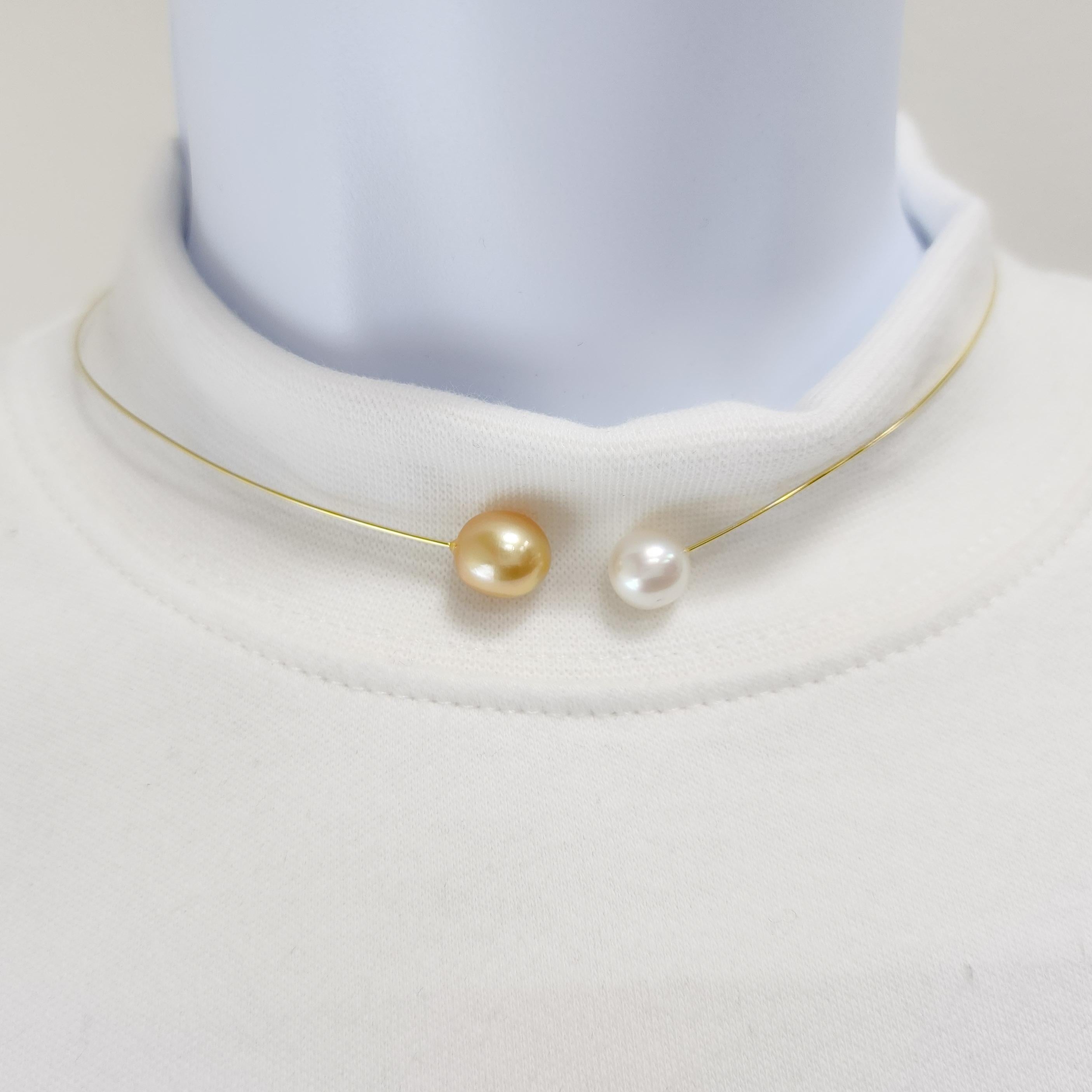 A very fun and modern necklace featuring a 9-10 mm golden pearl and white pearl.  Handmade in 18k yellow gold wire.  Flexible and easy to wear for any neck size.