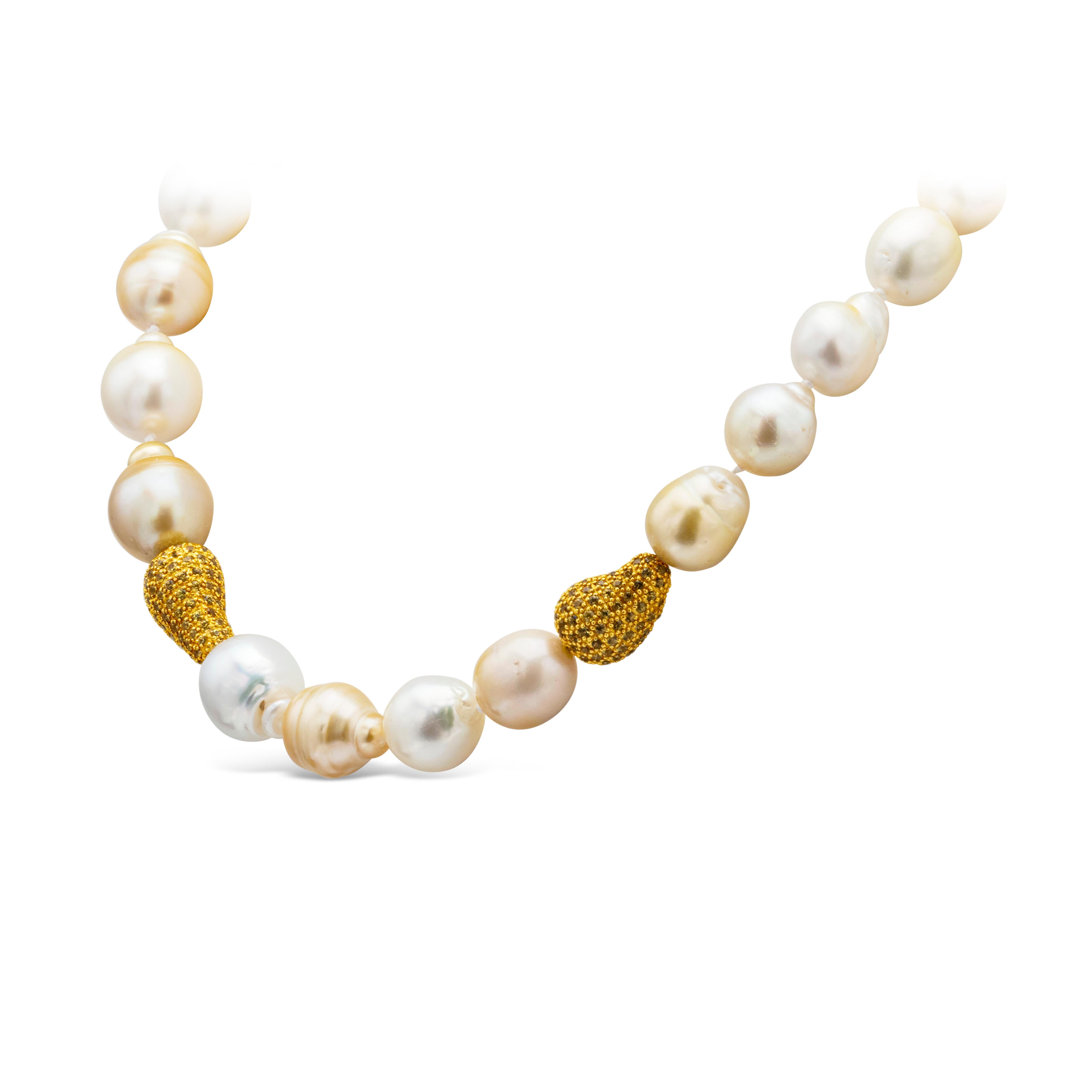 Magnificent necklace showcases 22 pieces of South Sea golden and white baroque Pearls. These beautiful pearls are approximately 12.2-15.3mm diameter and Perfectly offset by the yellow sapphire pave clasps.