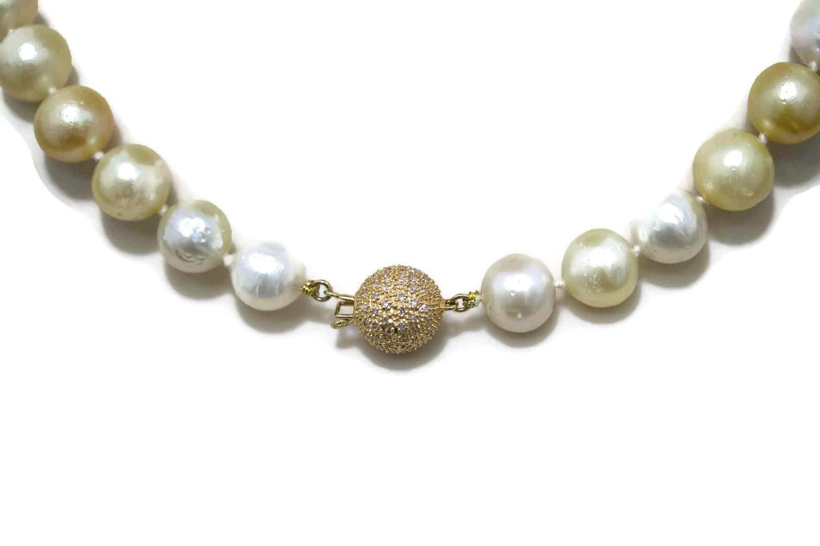 This stunning Golden and White South Sea Pearl Necklace With An 14k Yellow Gold Diamond Clasp is a basic classic South Sea Pearl necklace with a twist.  The combination of the yellow and white pearls make a very subtle and refined look to the