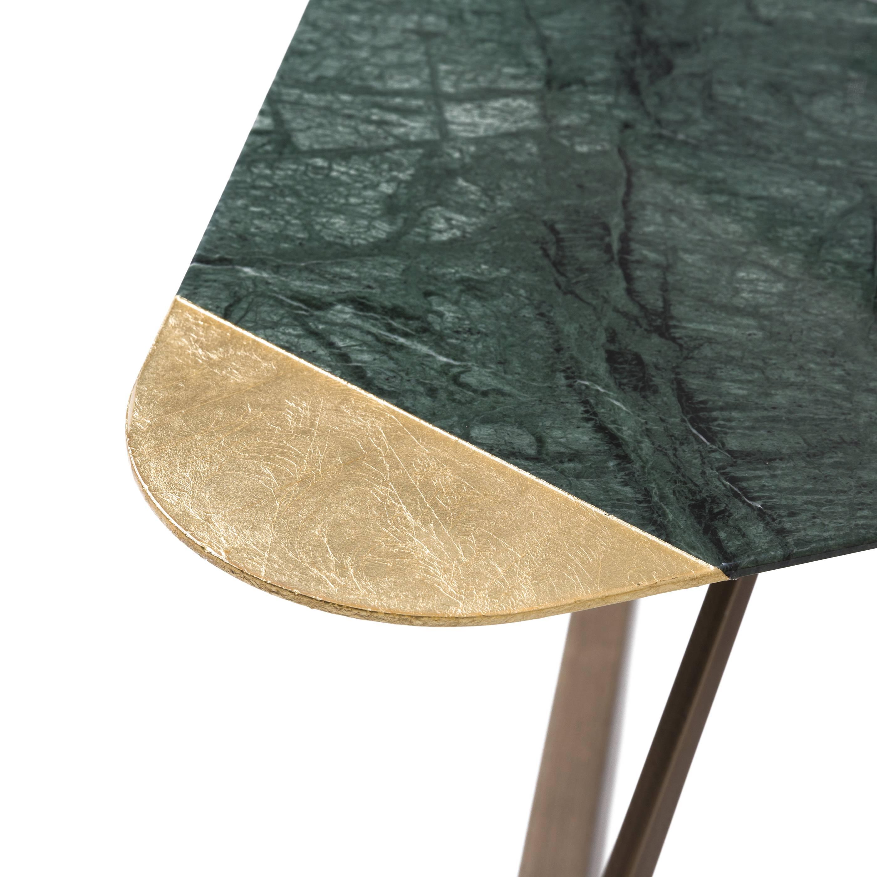 Golden Archer coffee table by Alex Mint

Marble-top and brushed bronze. 
Verde Guatemala - gold Leaf

The materials
Marble and stone collected from all over the world and combined carefully with timber and metal details are the main materials