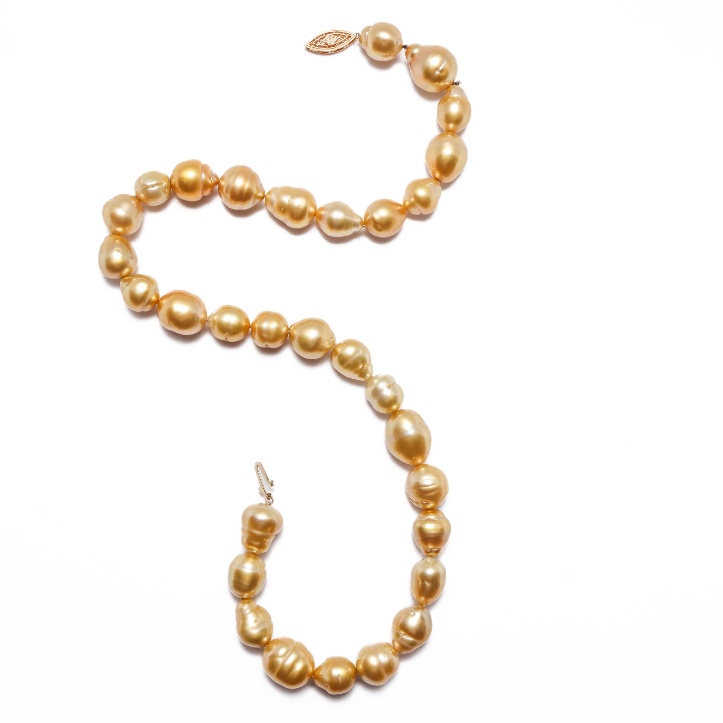 Thirty-one luminous and golden baroque South Sea pearls compose a new and unworn 17