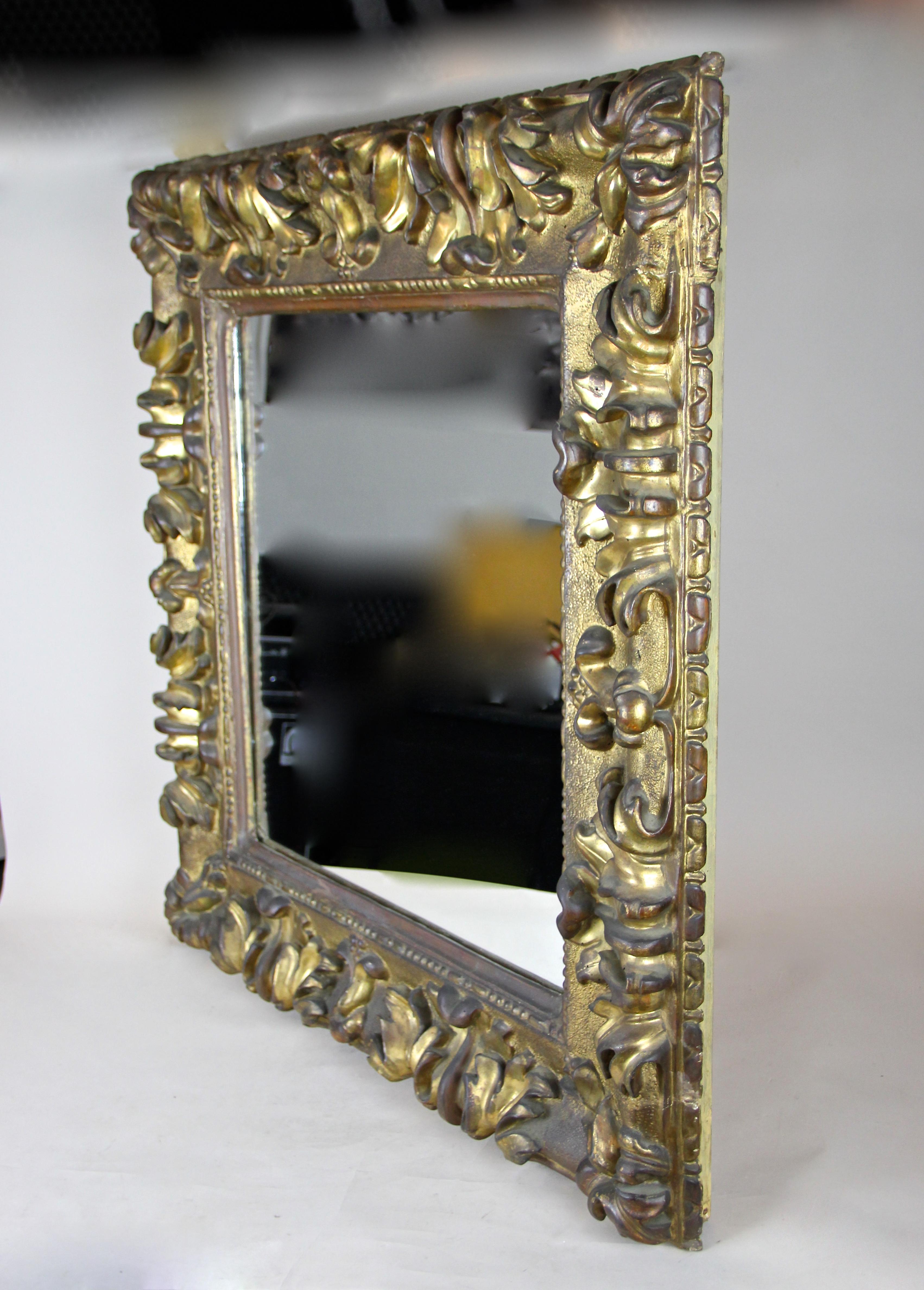 Absolutely outstanding gilt Baroque Wall Mirror from the very early 18th century in Austria. This solid mirror from around 1700 comes in amazing untouched condition. We only had to clean it carefully and renew the mirror glass during this process