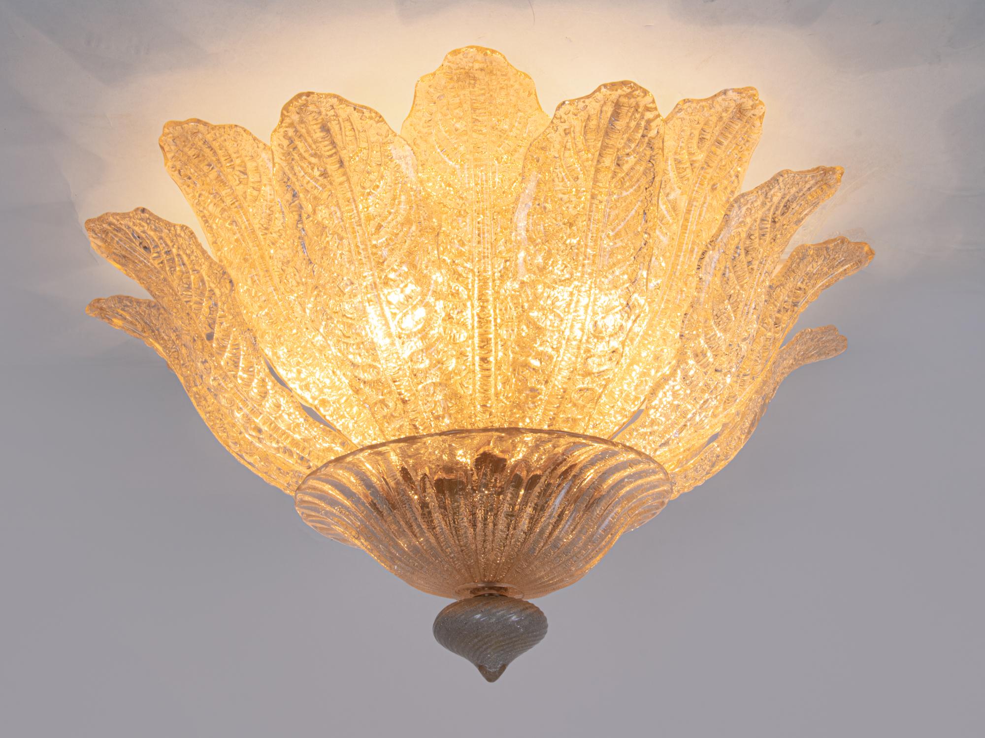 Elegant amber-colored Murano ceiling light with textured gold-dusted Murano glass leaves on a golden brass frame. An elegant floral chandelier made of hand-blown Murano glass in amber-golden “Rugiada” technique. Heavy duty. Has 6 sockets. In very