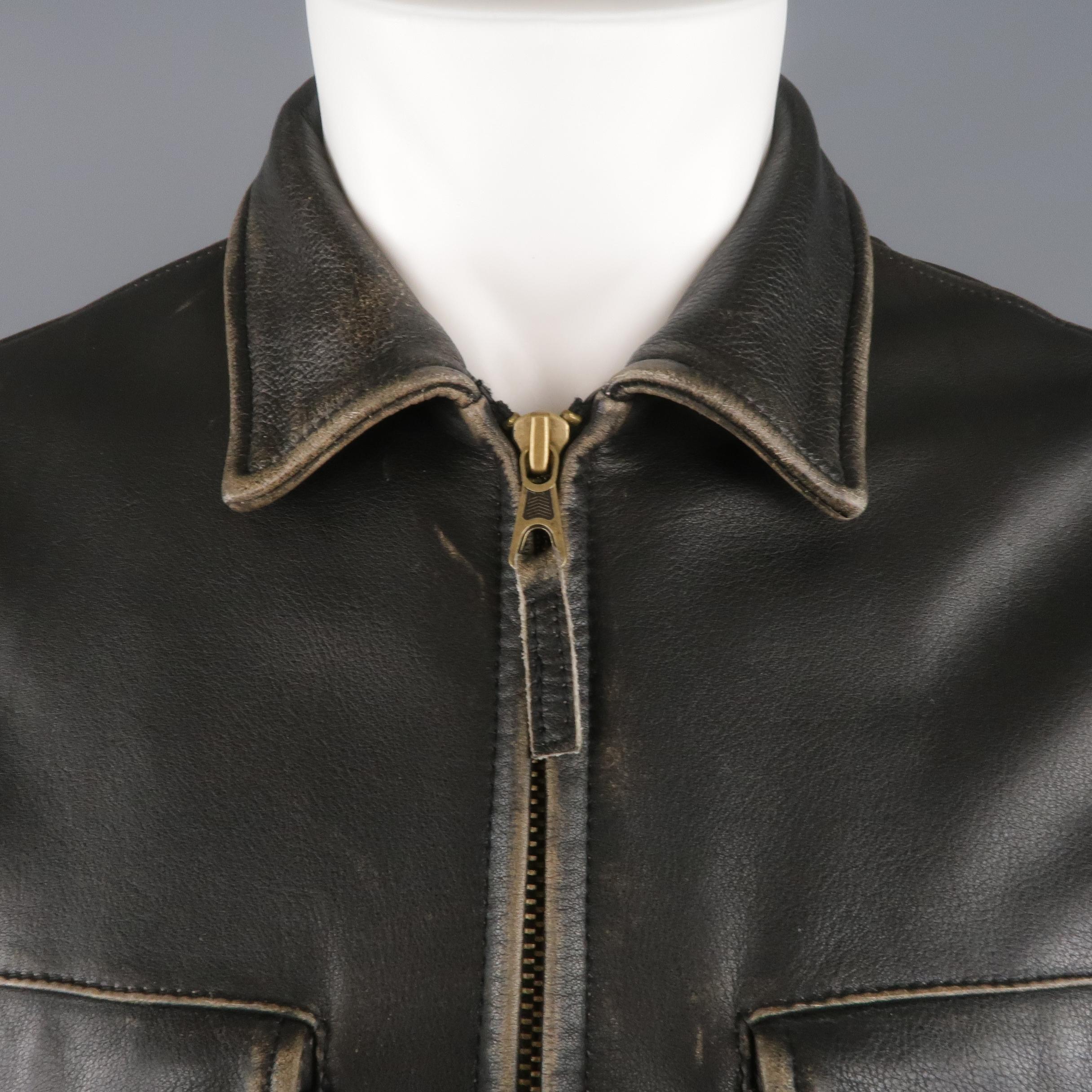 GOLDEN BEAR jacket comes in dark brown vintage look distressed leather with a pointed collar, zip front, snap flap chest pockets, slanted zip pockets, and zip cuffs. Made in USA.
 
Excellent Pre-Owned Condition.
Marked: M
 
Measurements:
 
Shoulder: