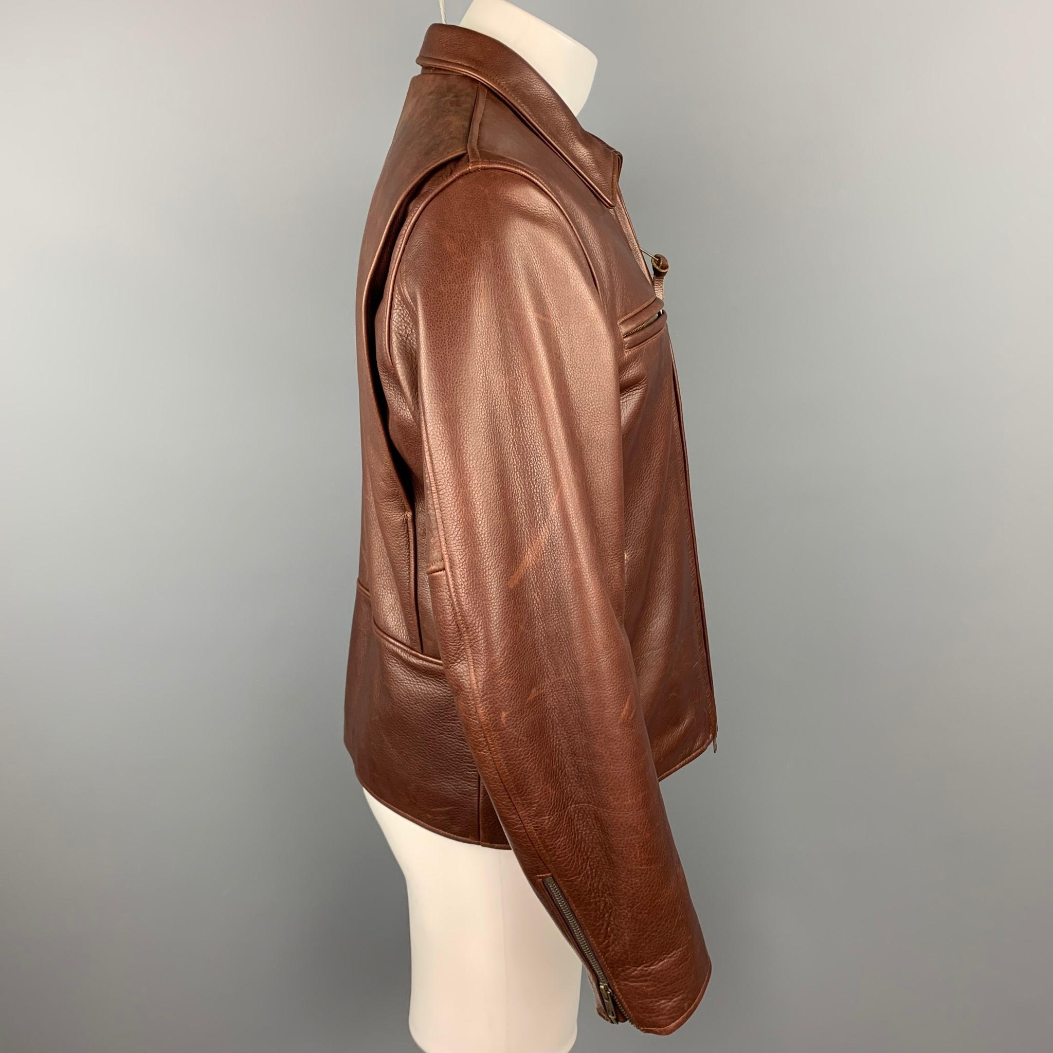 GOLDEN BEAR or TAYLOR STITCH jacket comes in a brown leather with a full liner featuring zipper sleeves, front slit pockets, spread collar, and a zip up closure. Made in USA.

Very Good Pre-Owned Condition.
Marked: L

Measurements:

Shoulder: 17.5