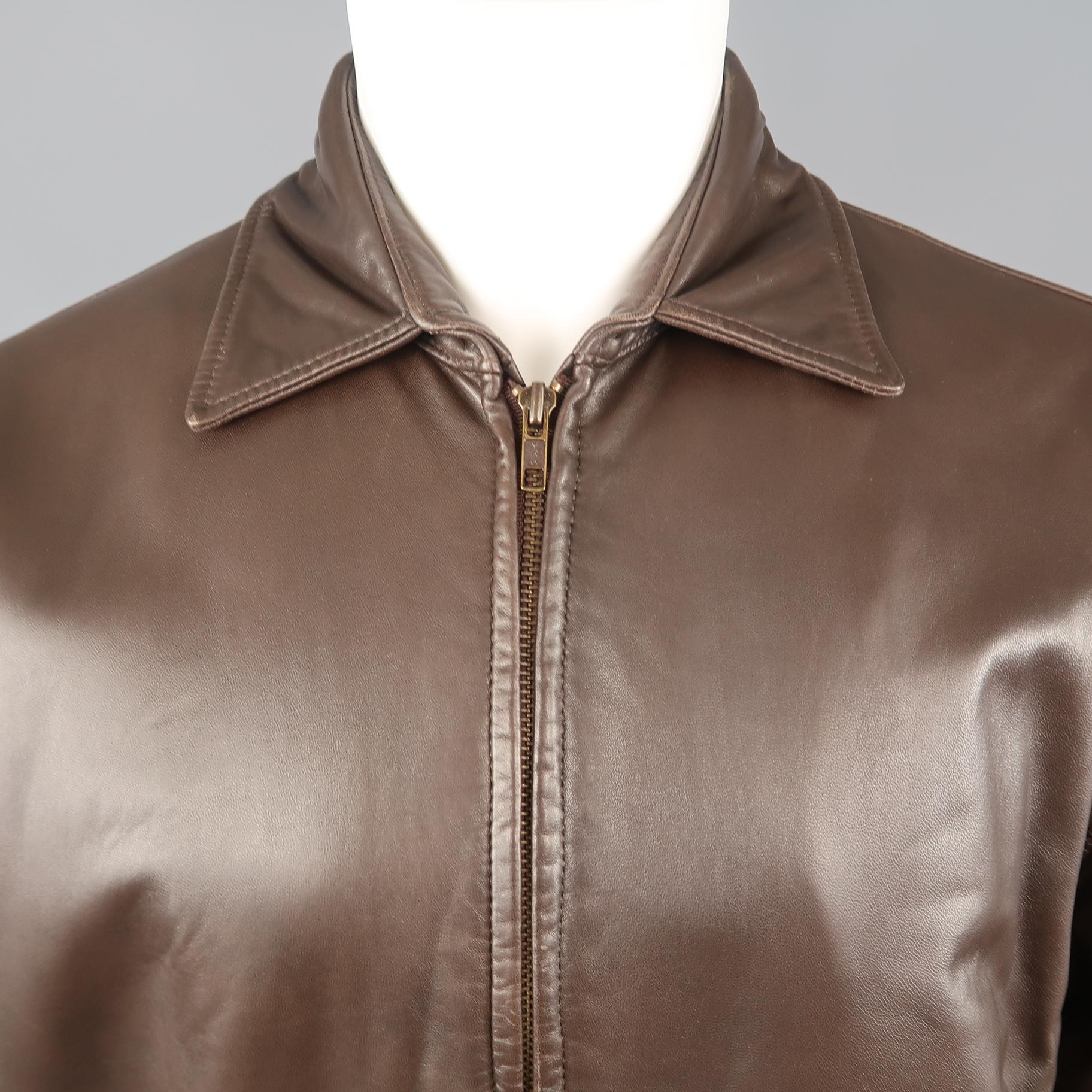 GOLDEN BEAR bomber jacket comes in smooth chocolate brown leather with a pointed collar, elastic waist, zip up front, and slanted pockets. Made in USA.
 
Excellent Pre-Owned Condition.
Marked: S
 
Measurements:
 
Shoulder: 20 in.
Chest: 46