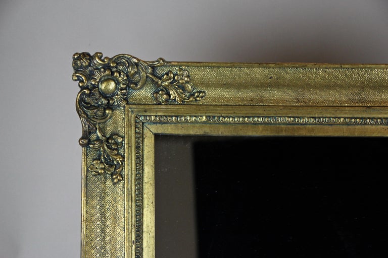 Enchanting golden Biedermeier wall mirror from the later Biedermeier period circa 1850 in Austria. With an age of nearly 170 years, this large antique mirror was restored by taking greatest care to keep its original unique character. The composition