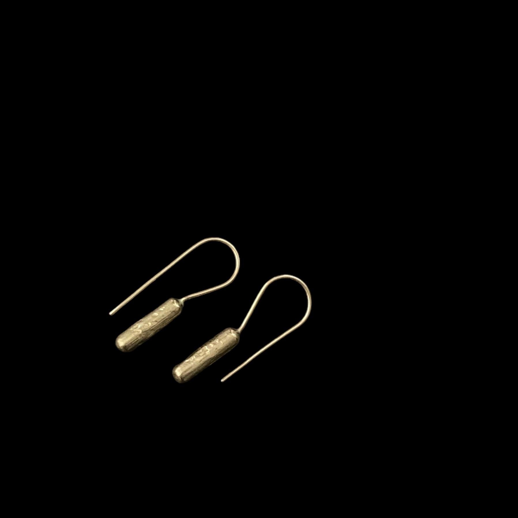 These earrings are elegantly shaped and perfect for everyday wear. 

They are fabricated from unocated golden brass, and the hook is made from gold filled wire. They are gently textured and are finished with a gentle, natural polish, to subtly catch
