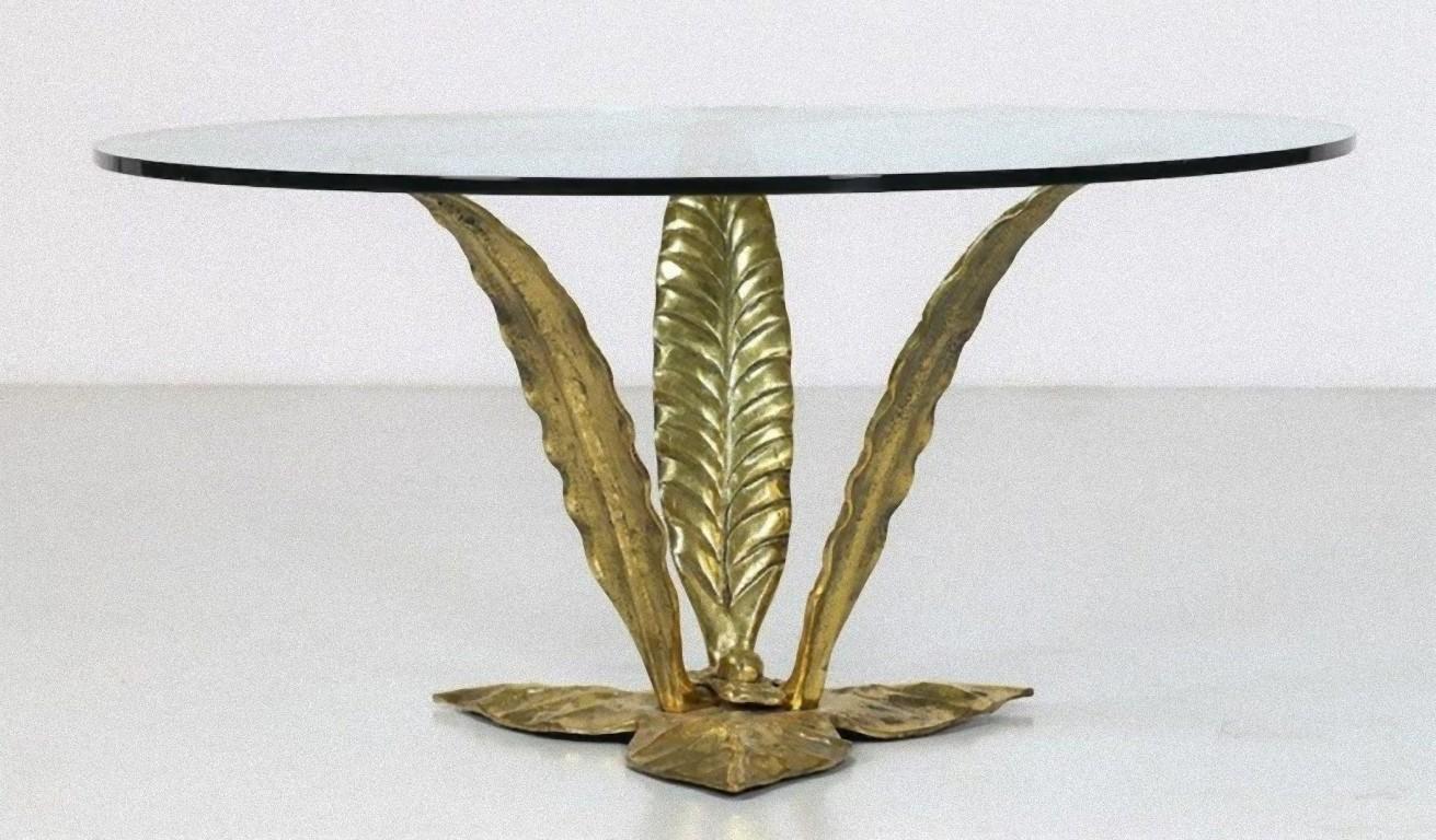 Golden vintage coffee table is a piece of original design furniture realized in the 1940s by Italian manufacture, with gilded bronze and crystal.

With three Golden leaves-shapes have an admirable creative design.

Good conditions.

This