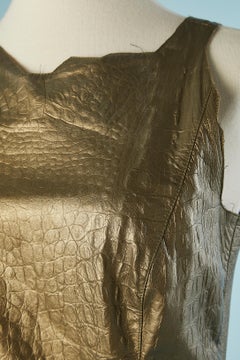 Golden brown sleeveless leather dress with crocodile pattern emboldened Mugler