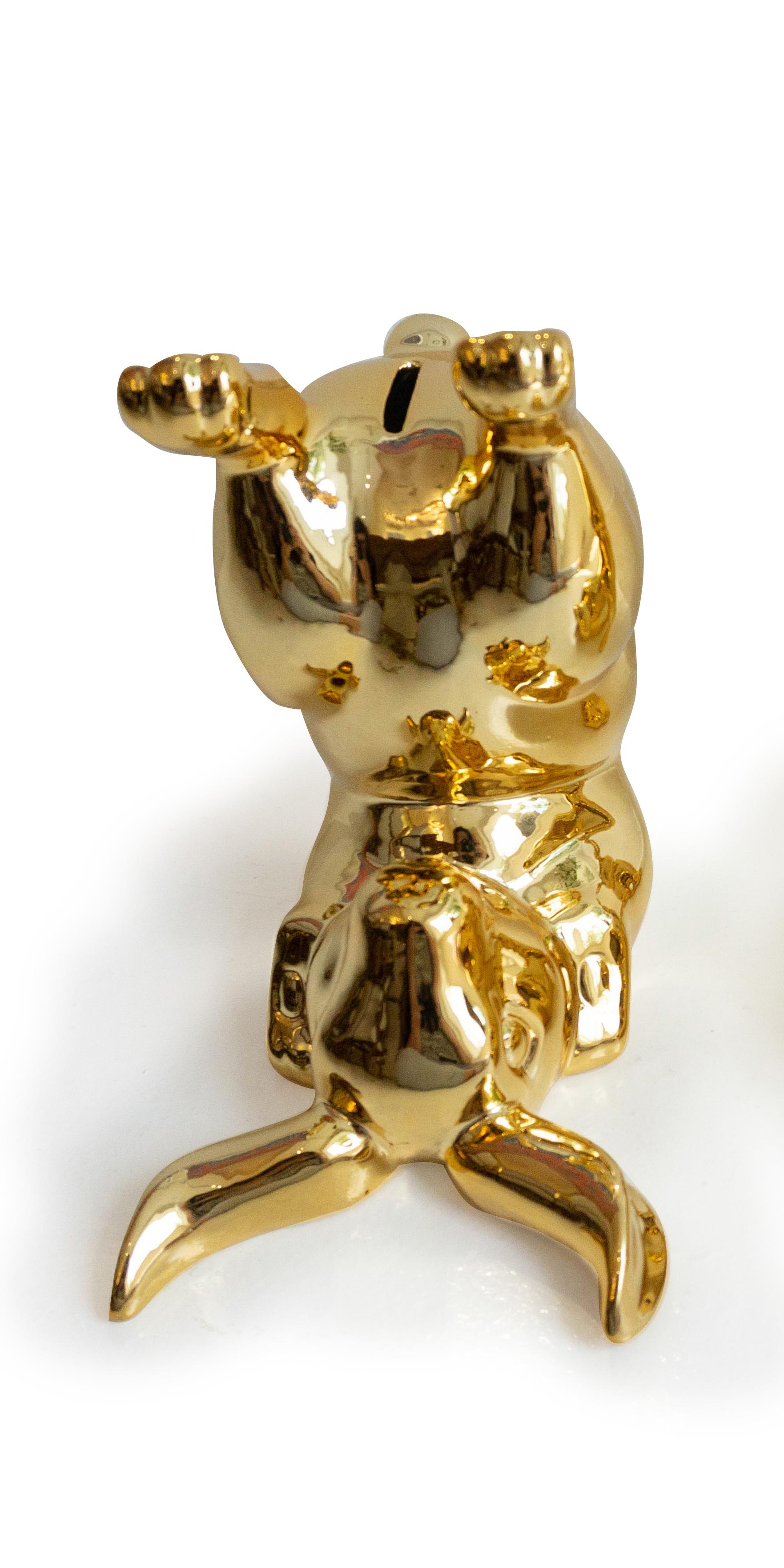 Porcelain gold money bank in the shape of a bunny. 

Measurements: 7” H x 6” W x 8” L.

 