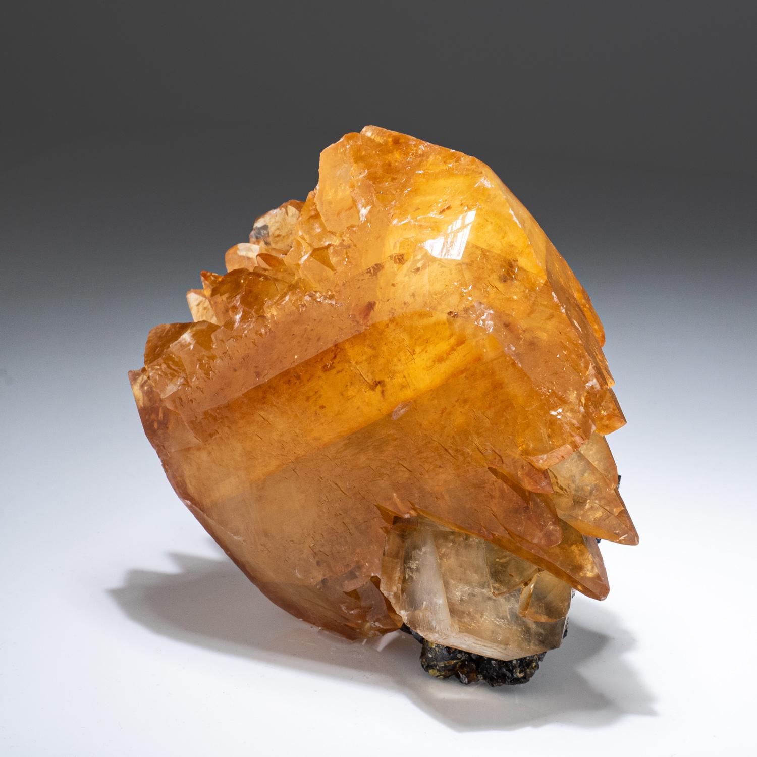 Lustrous transparent deep golden calcite crystal on matrix. Large double terminated scalenohedral twinned on the C-axis with well defined re-entrant faces. Small sphalerite crystal embedded on the back of the specimen. This rare specimen is an ideal
