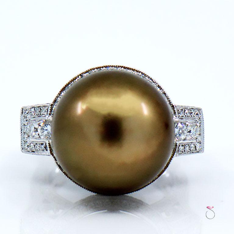 This gorgeous South Sea Pearl & Diamond Halo ring is just stunning. This ring features a 16.82 mm South Sea Pearl in the center Surrounded by a beautiful diamond halo. The Pearl features amazing golden, greenish, and chocolate color hues. This is a