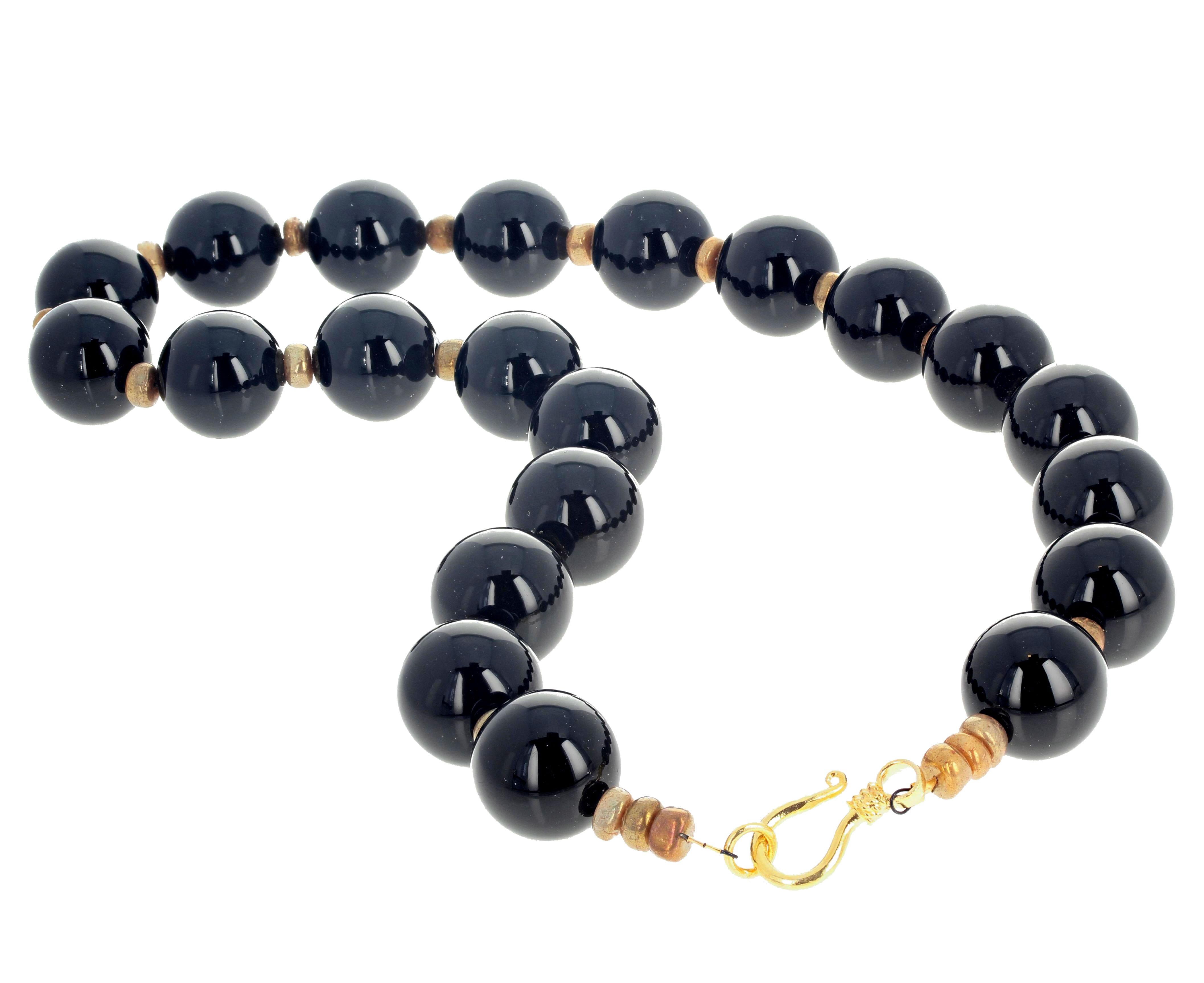 These highly polished glowing natural Black Onyx are enhanced with rounded polished glowing golden Coral rondels set in this gorgeous necklace 19.75 inches long with an easy to use gold plated hook clasp.  The Onyx are 18mm.  