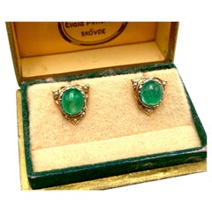Golden earrings with emeralds and pearls