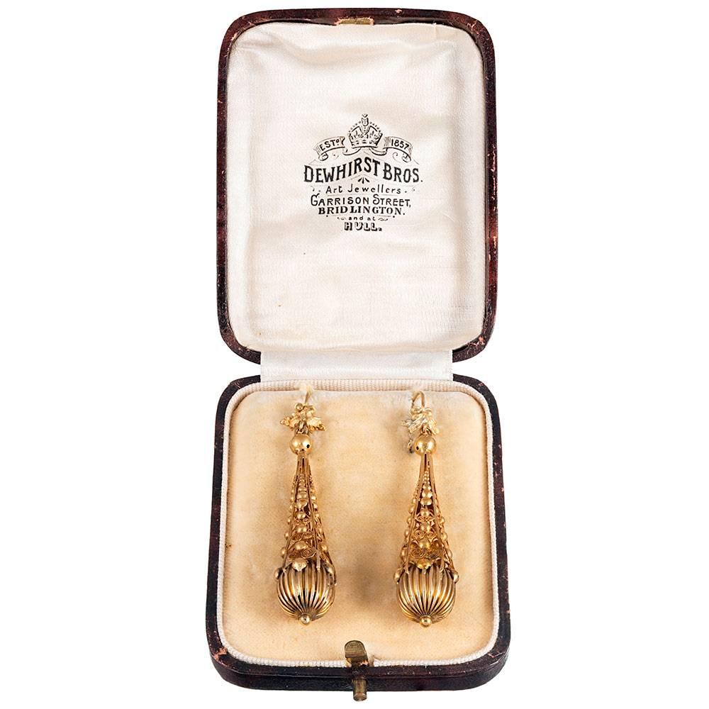 Magnificent antique earrings made of 18 karat and 22 karat yellow gold, showcasing the finest of Etruscan revival workmanship. The extensive detail becomes more evident the closer one looks. Measuring 2.25 inches in length, these early Victorian