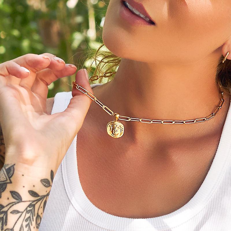 Story Behind The Jewelry
Our Exhale necklace has large 14K gold chains adorned with golden quartz. The medallion is a reminder of one's inner strength and reminder of where we are going and what we have overcome. The double sided medallion is