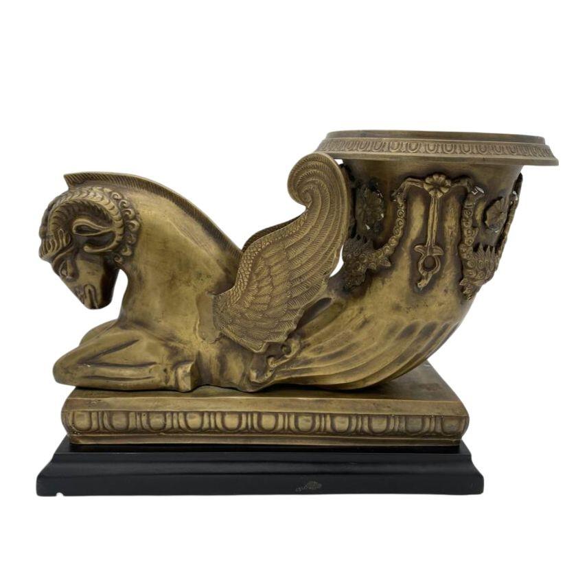 Early 20th Century Bronze mantle urn with black composite base featuring the Greek Golden Fleece Chrysomallos decorative with black composite base.

Measurements: Length: 14 3/4
