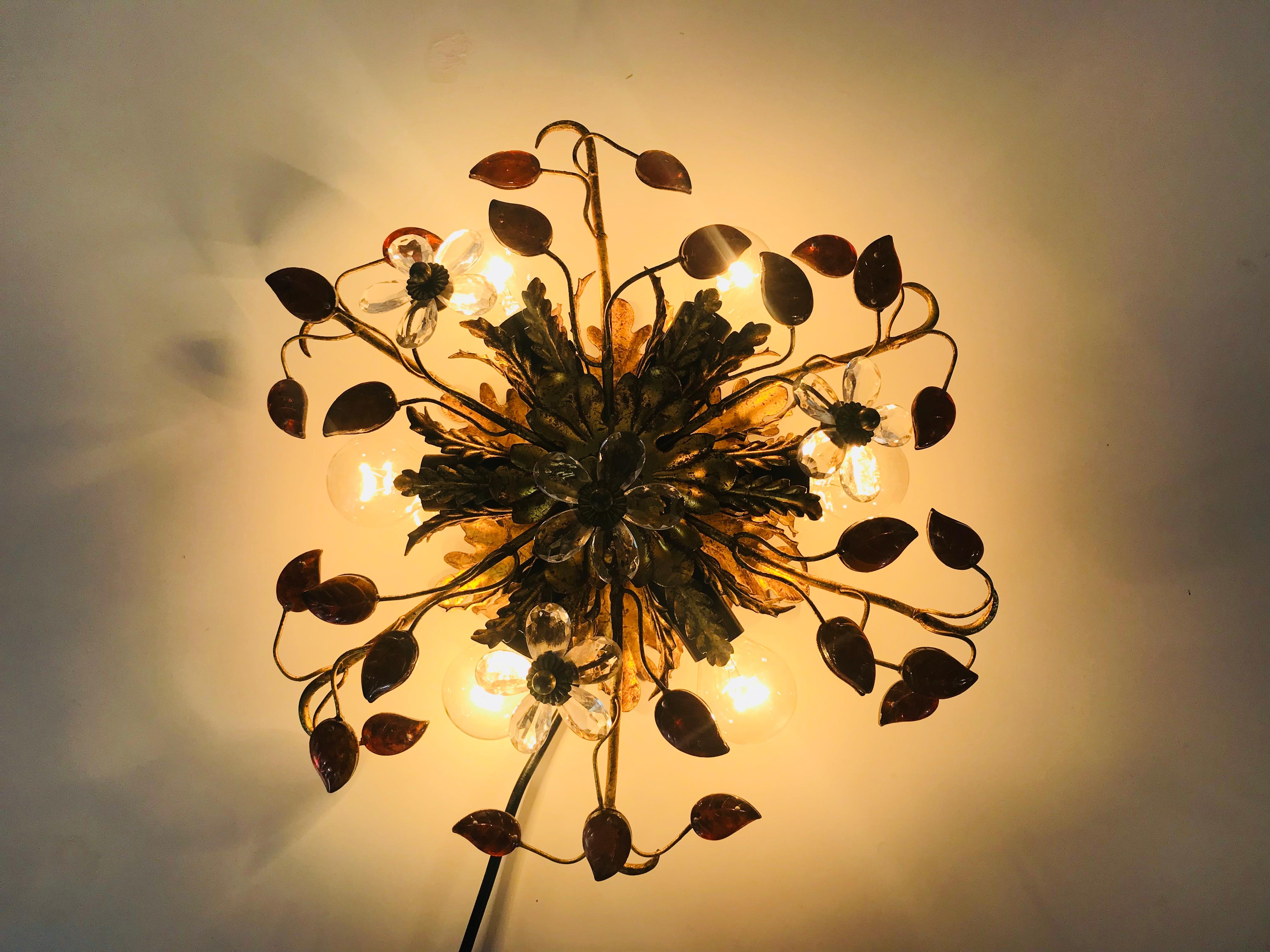 An extraordinarry flush mount by Banci made in Italy in the 1950s. The lamp has a beautiful wheat sheaf design. It is made in the period of Hollywood Regency. The orange leafs are made of Murano glass.

The light requires six E14 light bulbs.