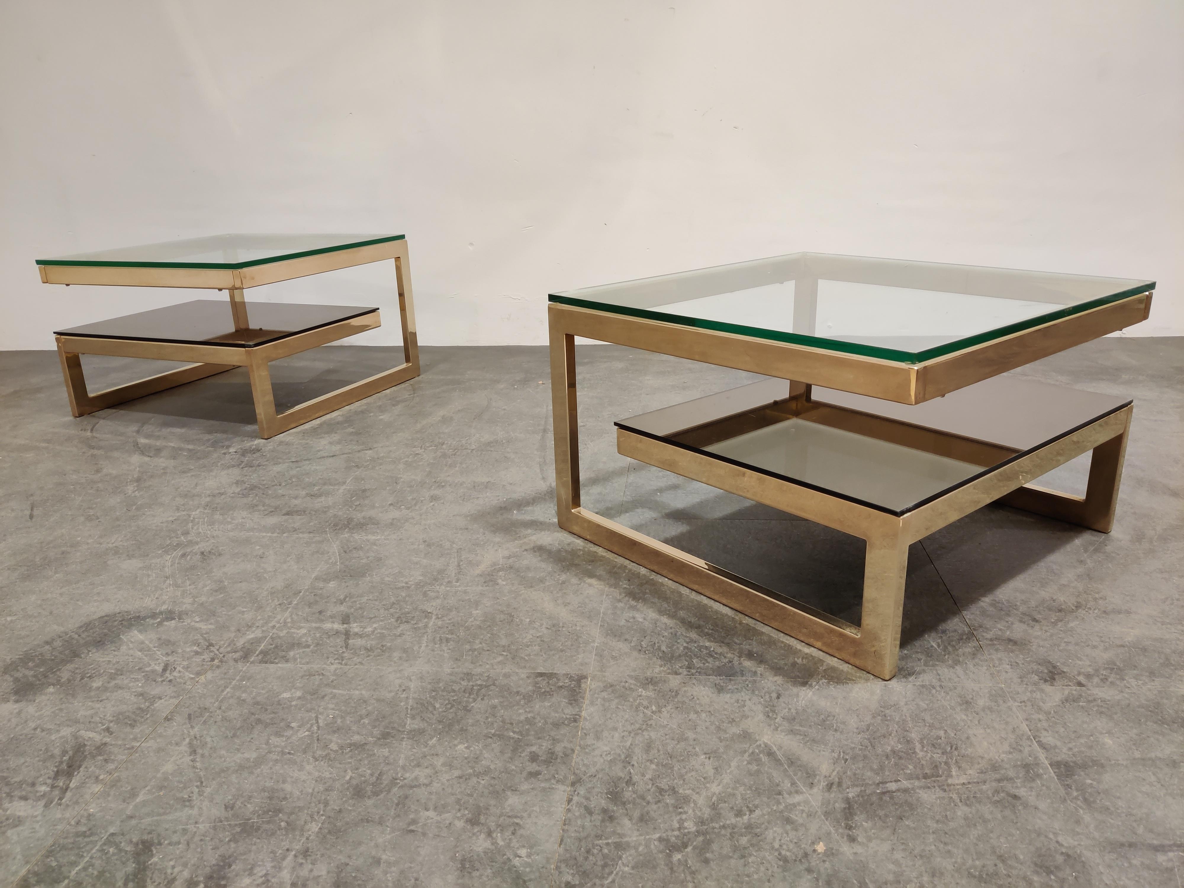 Pair of 23-karat gold layered 'G'-shaped side tables produced by Belgochrom.

The tables have clear and mirrored glass tops.

Good condition, original glass.

1970s - Belgium

Measures: Height 37cm/14.56
