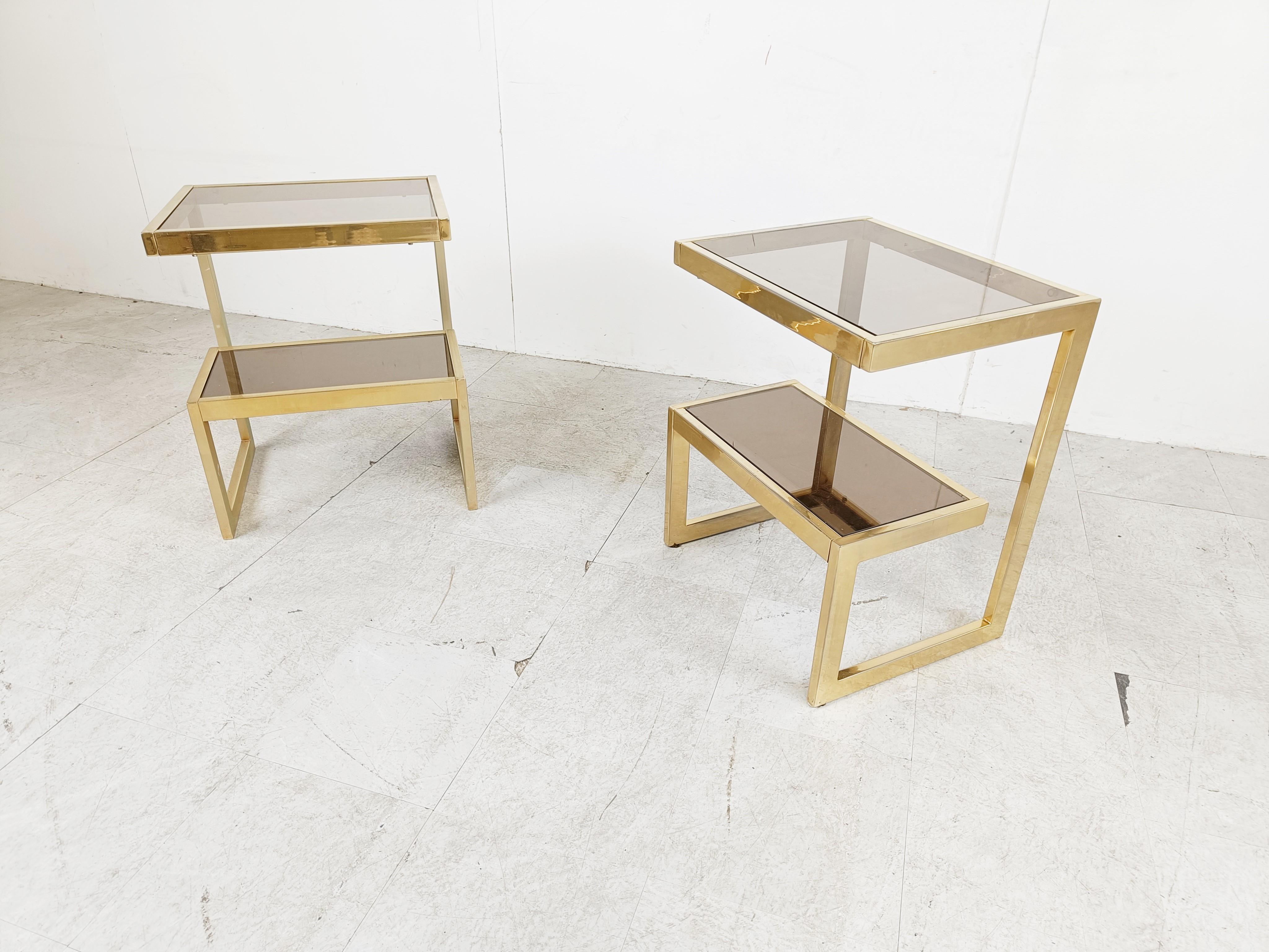 Pair of 23k gold layered 'G'-shaped side table produced by Belgochrom.

The tables have smoked glass tops.

Good condition, original glass.

1970s - Belgium

Height: 60cm/23.5