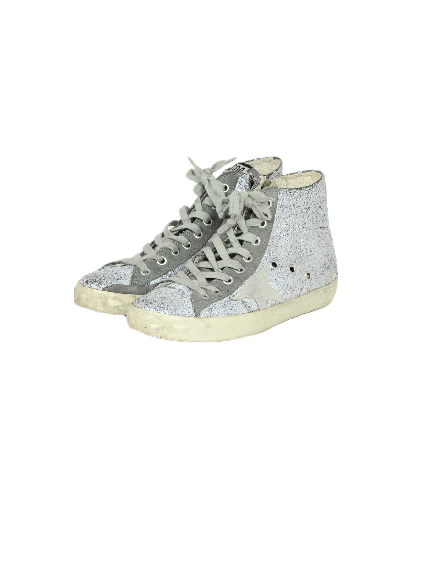 Golden Goose Deluxe Brand Silver Glitter Francy High Top Sneakers sz 36

Made In: Italy
Color: Grey, Silver, White
Hardware: Silvertone
Materials: Leather, Glitter
Closure/Opening: Front Laces
Overall Condition: Excellent pre-owned condition.
