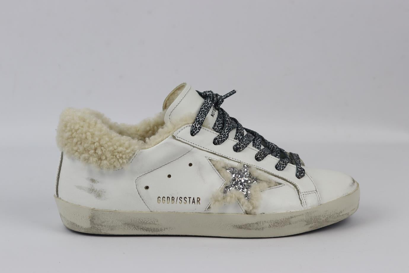 Golden Goose Deluxe Brand Superstar shearling lined leather sneakers. White, cream, silver and black. Lace up fastening at front. Does not come with dustbag or box. Size: EU 38 (UK 5, US 8). Insole: 9.8 in. Heel Height: 1.3 in. Very good condition -