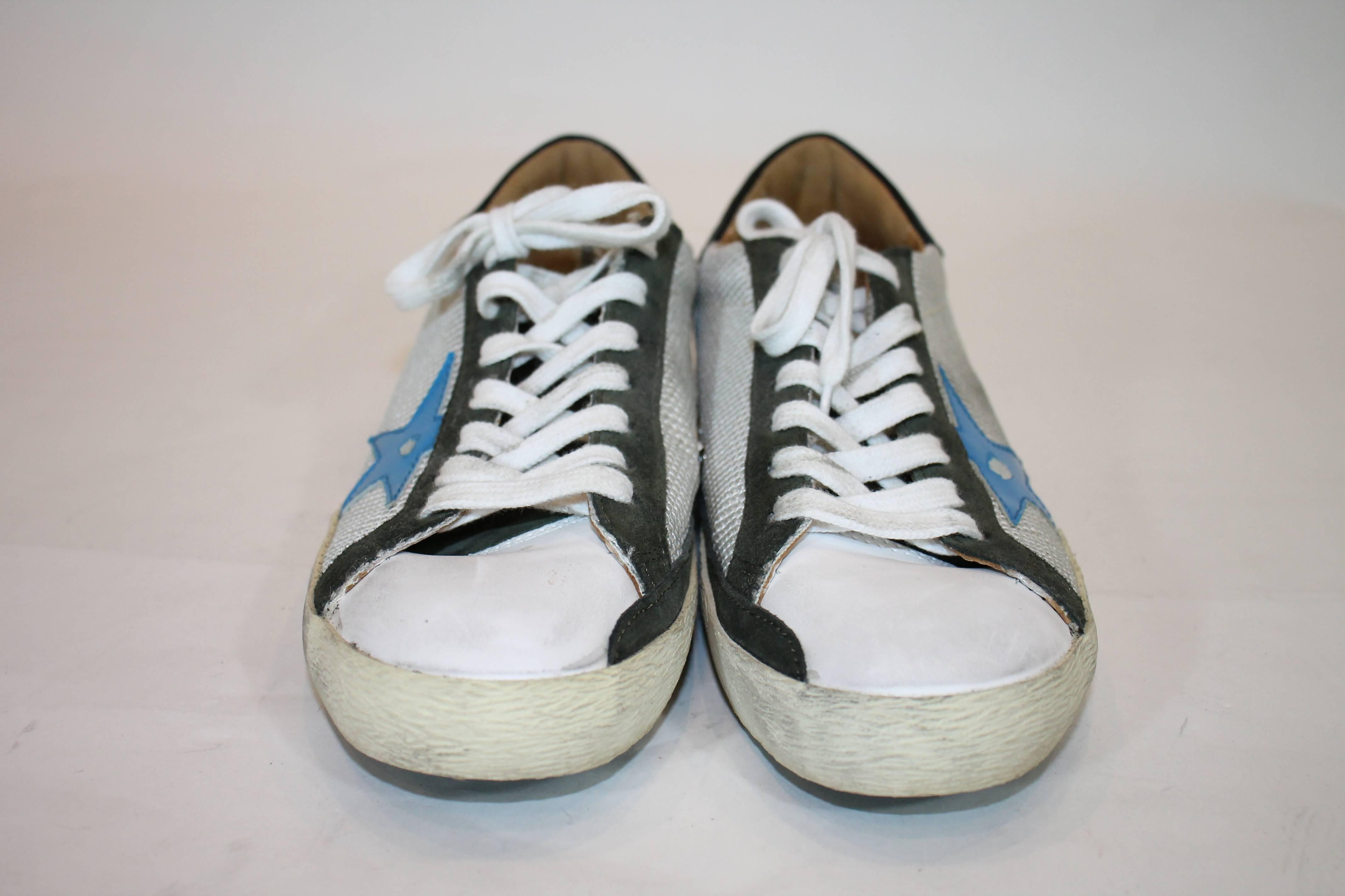 Golden Goose Deluxe Brand 'super star' sneakers in white, green and blue. Suede and canvas. Featuring a round toe, a contrasting star patch at the side, a lace-up front fastening, a brand embossed tongue and a white rubber sole. Original Price $575.