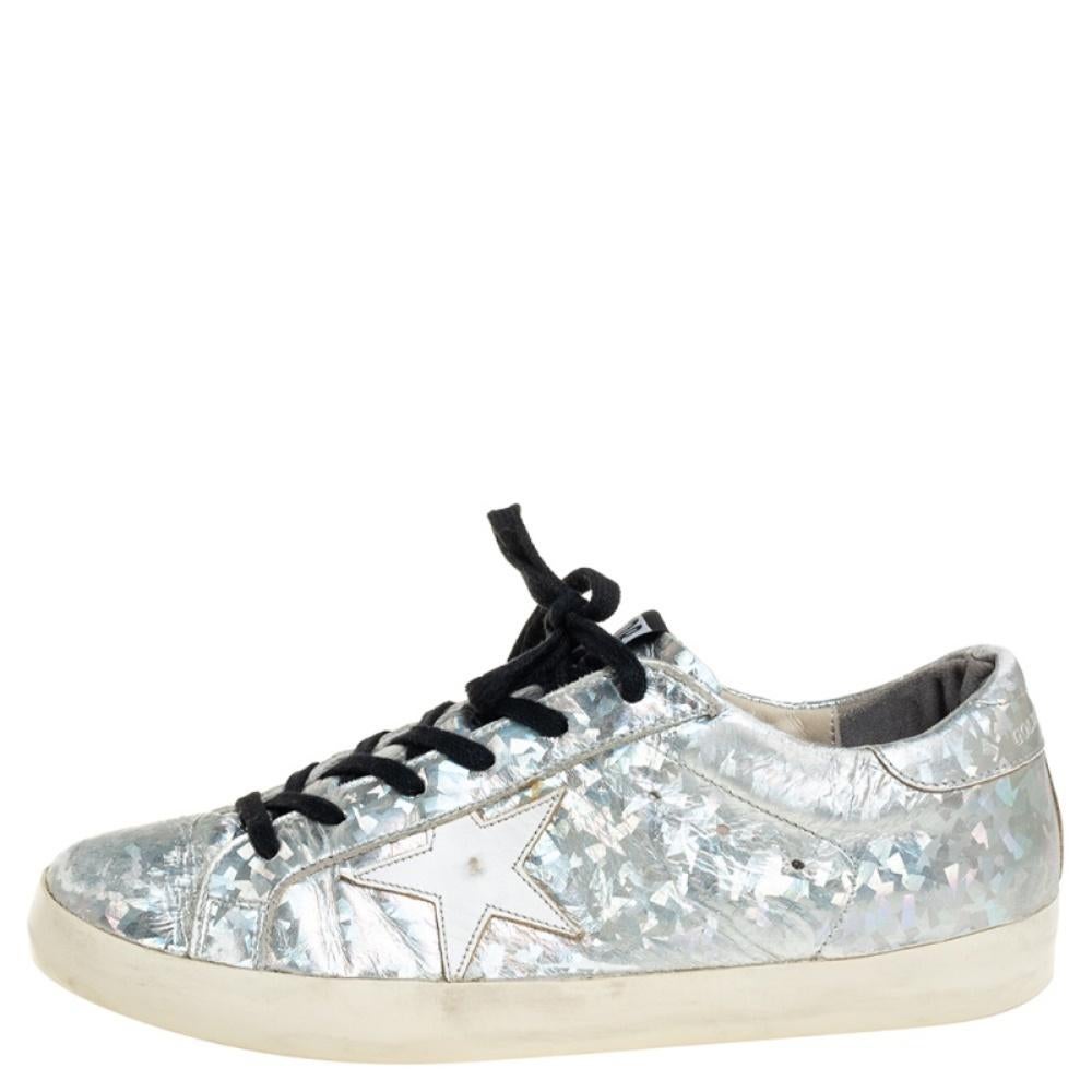 Founded in 2000, Golden Goose is hailed for meticulous craftsmanship in shoemaking and creative designs fused with a vintage appeal. Made from grey leather, they feature a distressed finish, laces on the vamps, and their signature star motifs on the