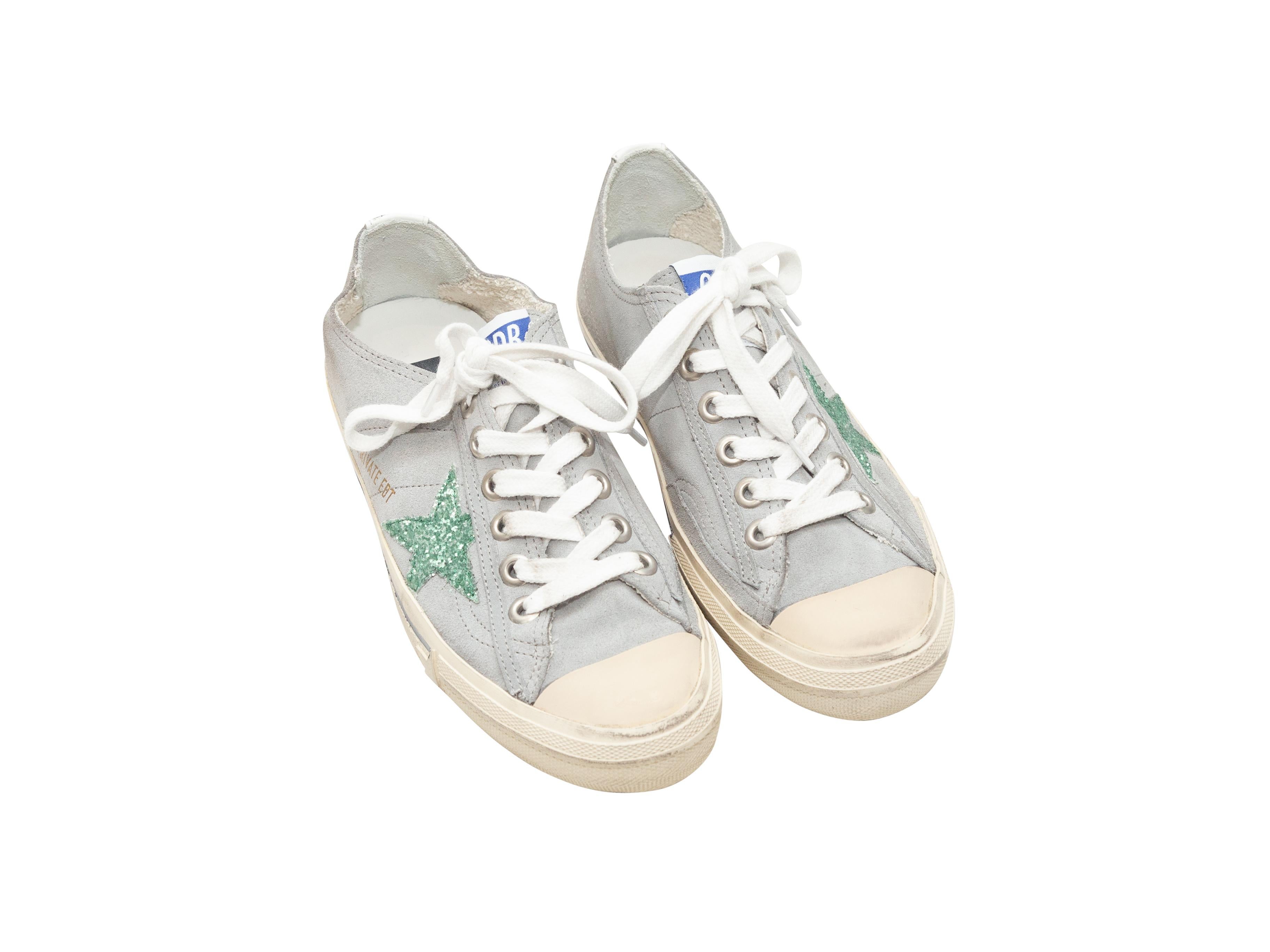 Product details: Grey and mint suede cap-toe low-top sneakers by Golden Goose. Star detailing at sides. Rubber soles. Lace-up tie closures at tops. Designer size 37. 4