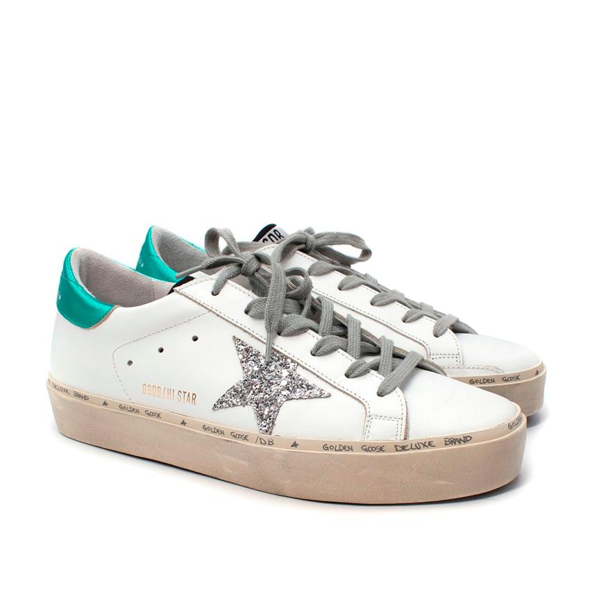 Golden Goose Hi Star White Leather Silver Star Trainers
 

 - White leather upper featuring signature distressing, and textured silver glitter star
 - Contrasting metallic green heel cushion
 - Rubber sole, with logo handwriting on the midsole
 -