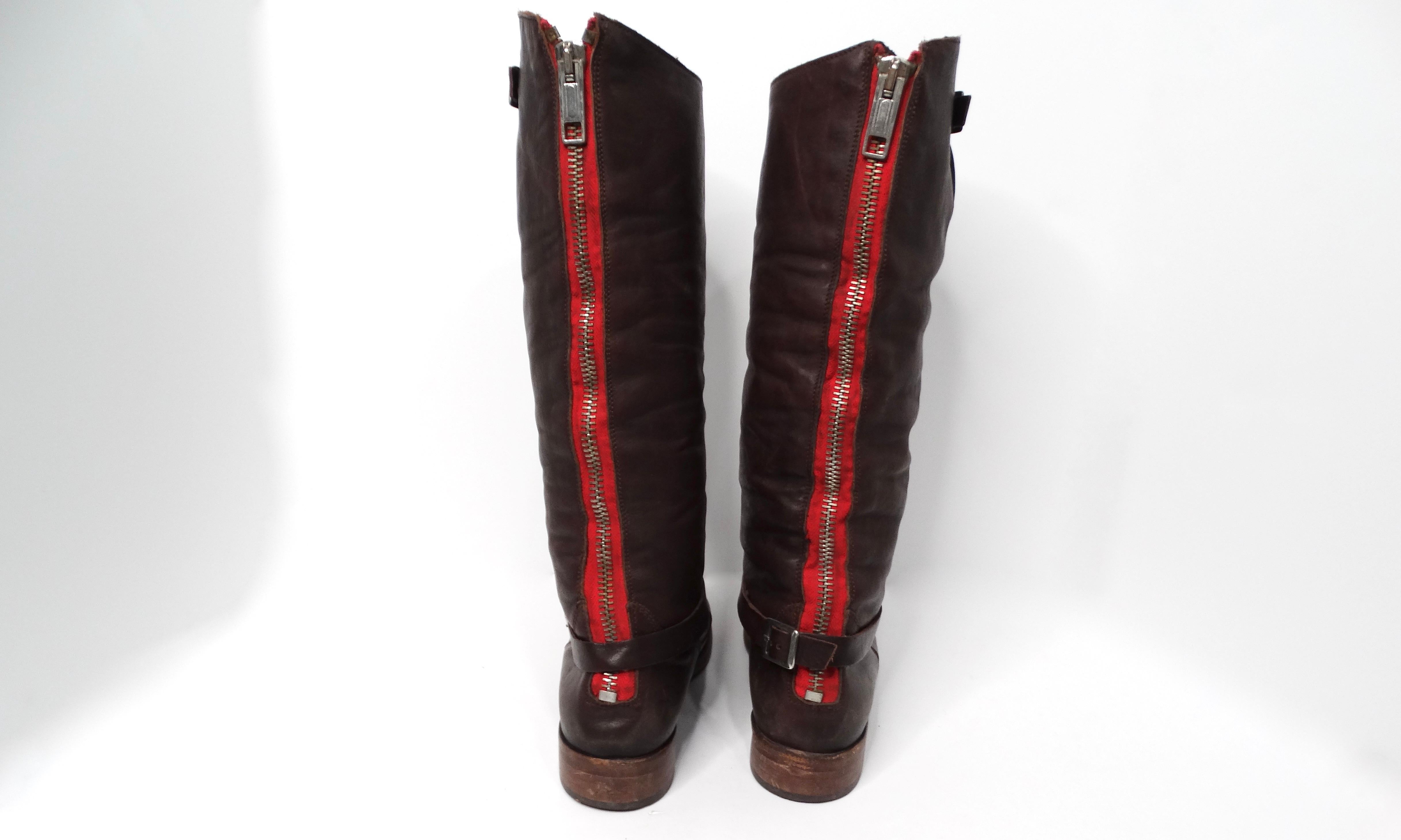Step into luxury with the Golden Goose Limited Handmade Brown Leather Riding Boots, a perfect blend of craftsmanship and style. These exquisite riding boots feature a striking red zipper running down the back, which adds a bold pop of color and