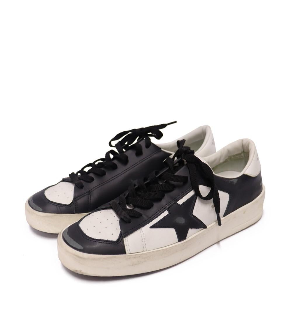 Golden Goose Men's Stardan Sneakers, Features a black and white leather upper, rubber soles and lace up style.

Material: Leather
Size: EU 41
Overall Condition: Good
Interior Condition: Signs of use
Exterior Condition: Light stains
*Includes dust bag