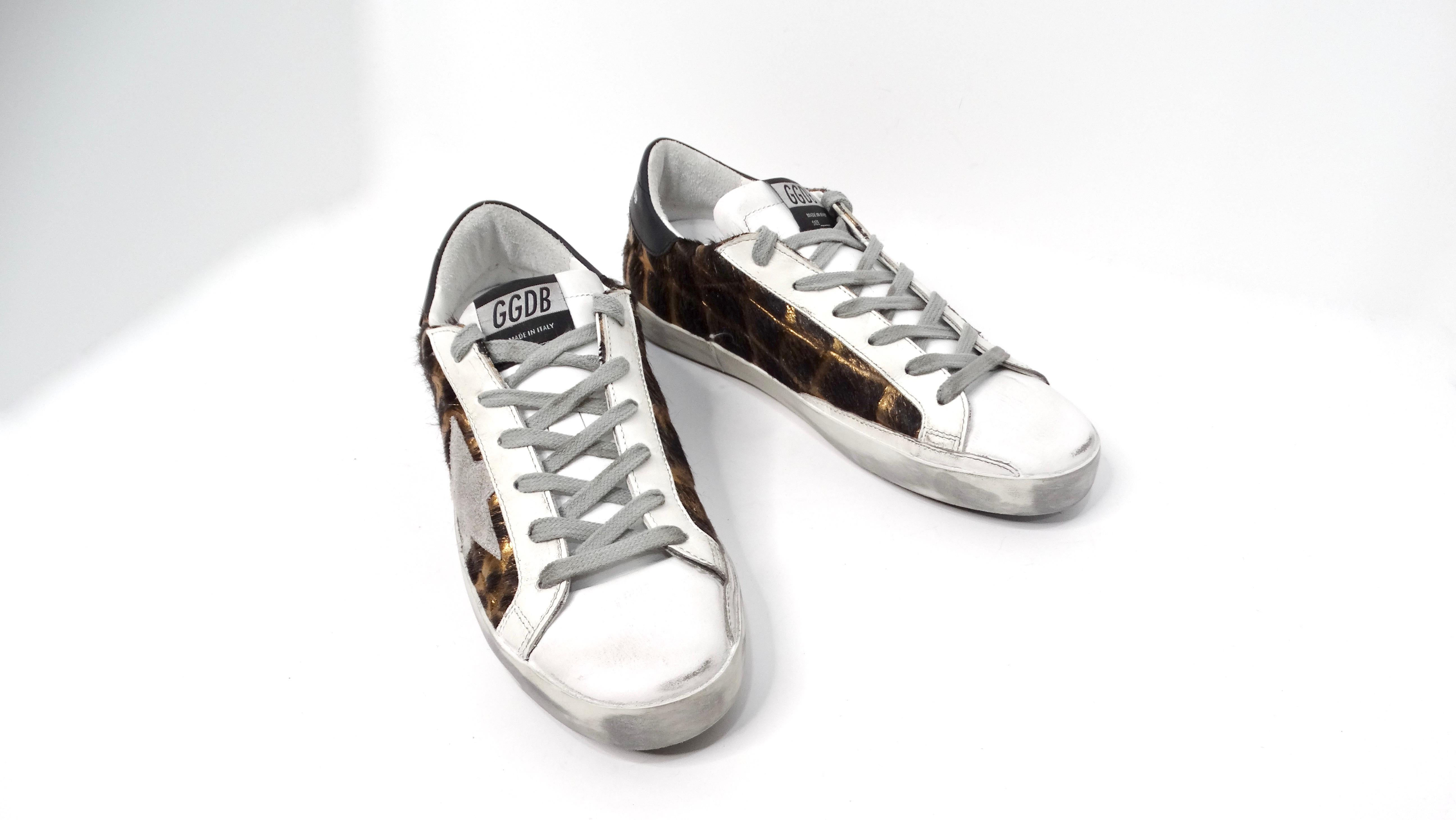 Introducing the stunning Golden Goose Metallic Leather Animal Print Sneakers, a perfect fusion of contemporary style and trendy flair. These low-top sneakers feature an eye-catching metallic leather animal print elegantly showcased on the sides,