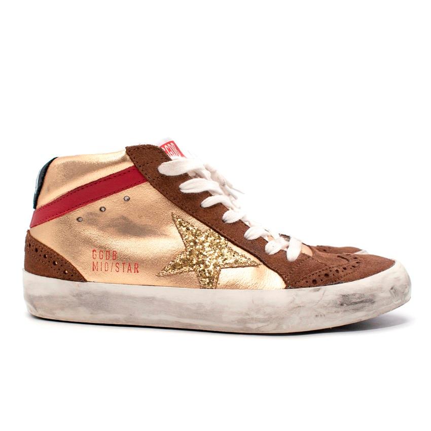 Golden Goose Mid Star Gold Glitter Star Sneakers

- The perfect blend of sporty and casual style
- Metallic gold-tone laminated leather and brown suede provide the backdrop for a gold glitter star and contrasting red stripe
- Round toe finished with