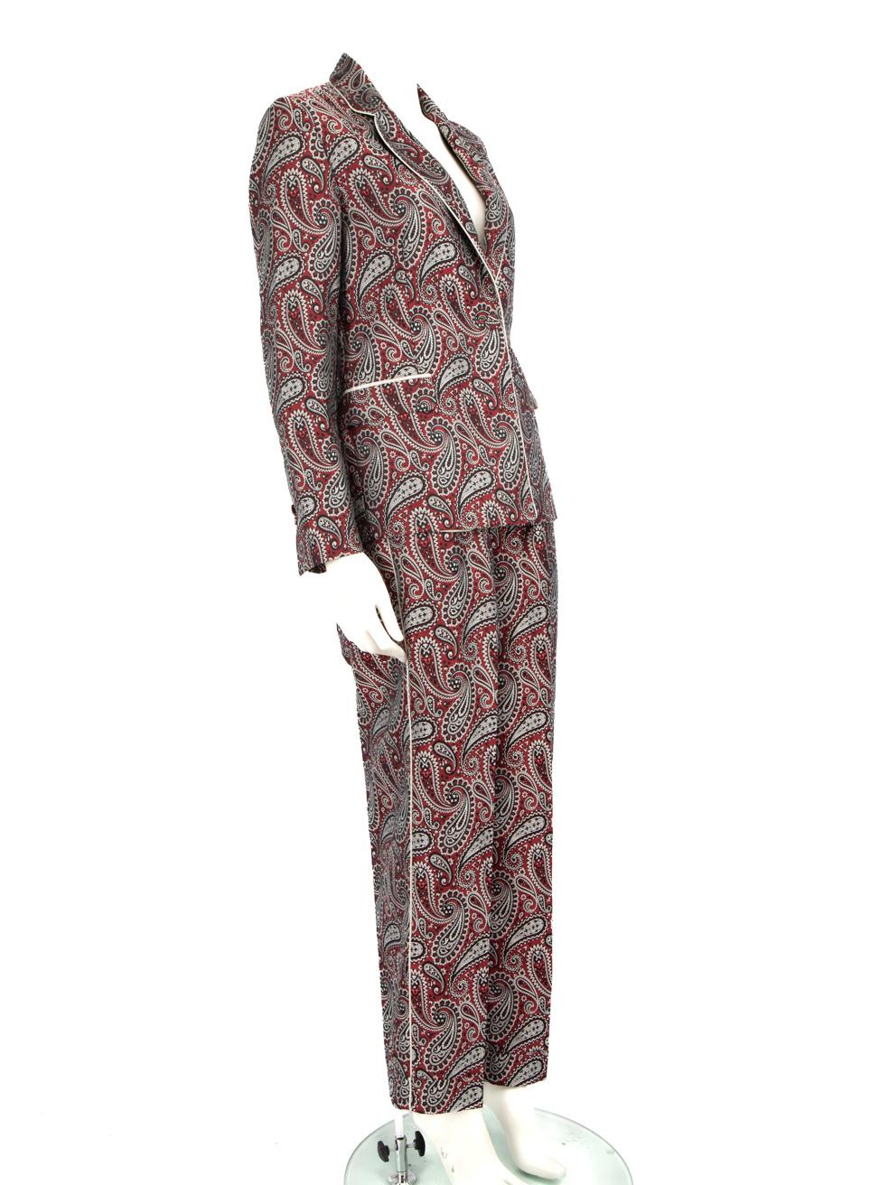 CONDITION is Very good. Minimal wear to blazer and trousers is evident. Minor pulls to the weave on the piping on the back of the blazer collar, as well as the piping on the right side trouser leg. Left trouser leg and blazer lining fabric has minor