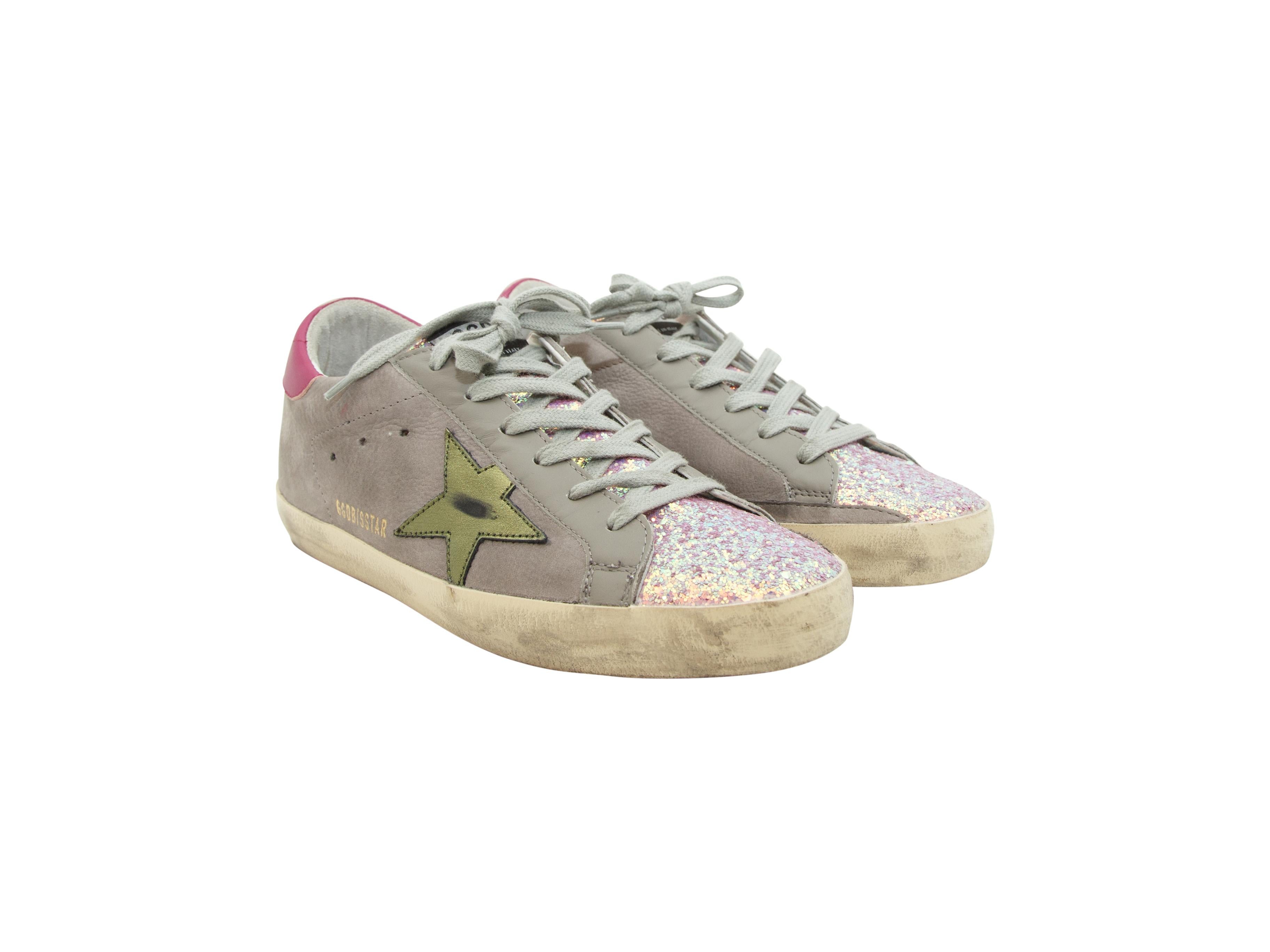 Product details:  Pink Glitter sneakers by Golden Goose.  These leather sneakers have pink glitter accents, where pink glitter is on the toe box and goes up through the throat of the sneakers. The back of the collar has a pink leather label with