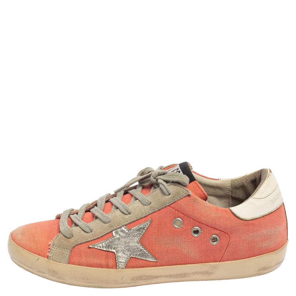 Enjoy footwear ease with this pair of sneakers by Golden Goose. They've been crafted canvas, suede, and leather and are designed with round toes, lace-up on the vamps, and the signature star motif on the sides. The leather insoles and rubber soles