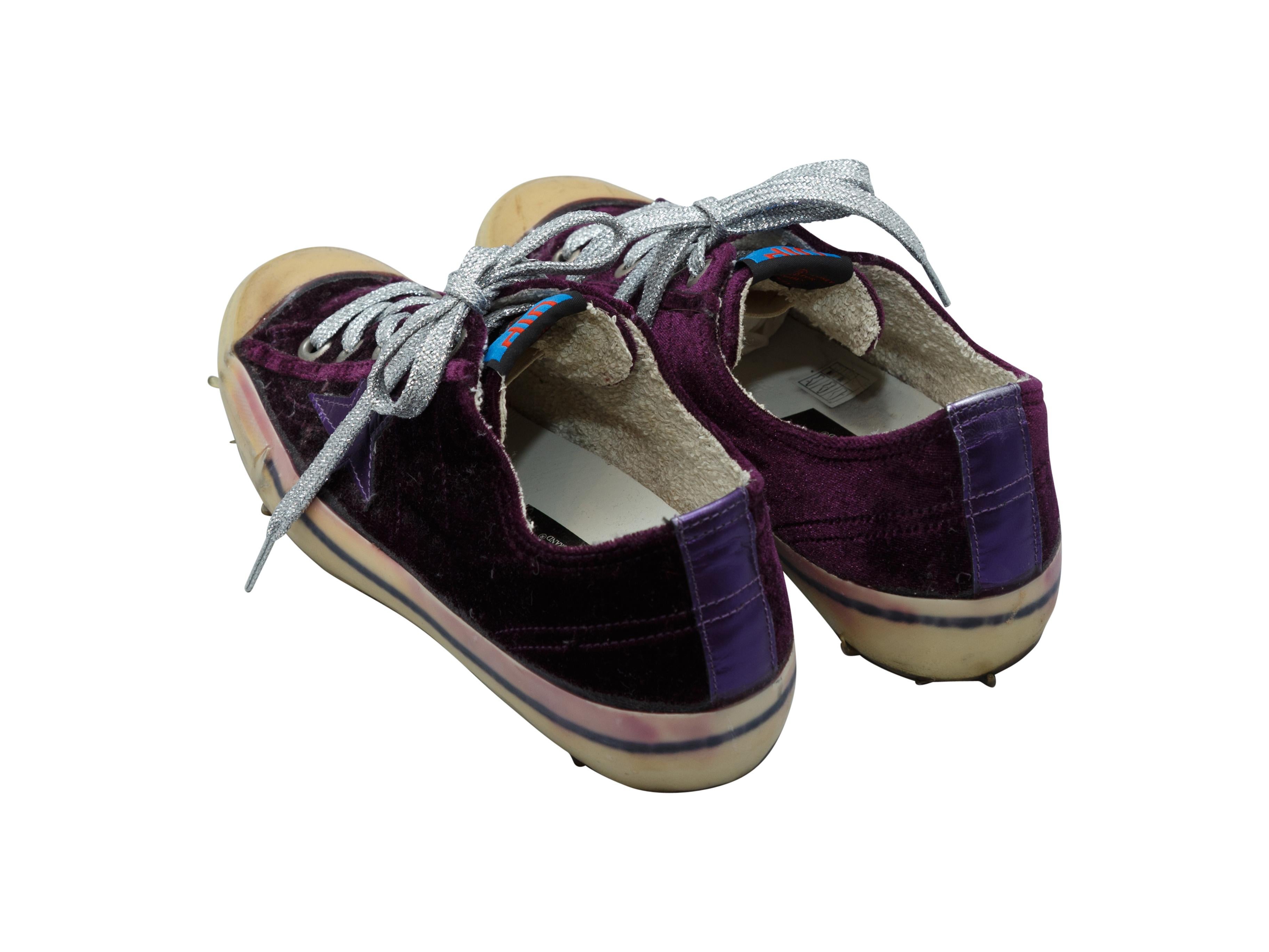 Product details: Dark purple velvet low-top sneakers by Golden Goose. Rubber cap-toes. Star stitching at sides. Lace-up closures at tops. 1.13