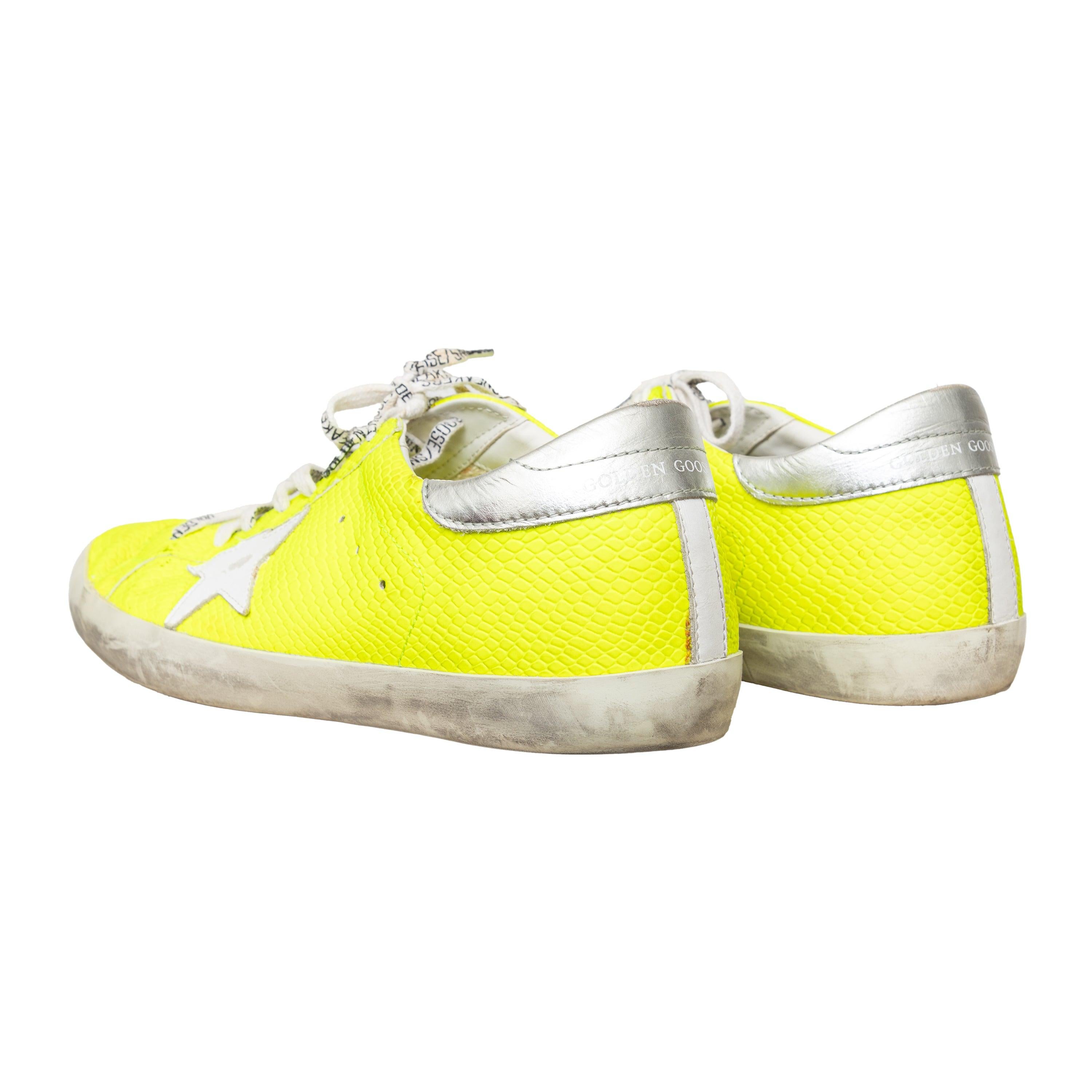 These Golden Gooses sneakers feature a distressed design with lizard printed leather in neon color. A low-top, classic style sneaker in the iconic Superstar model. 
 Measurement: Insole Length:29.5;Heel:2.5 
 Material: Leather