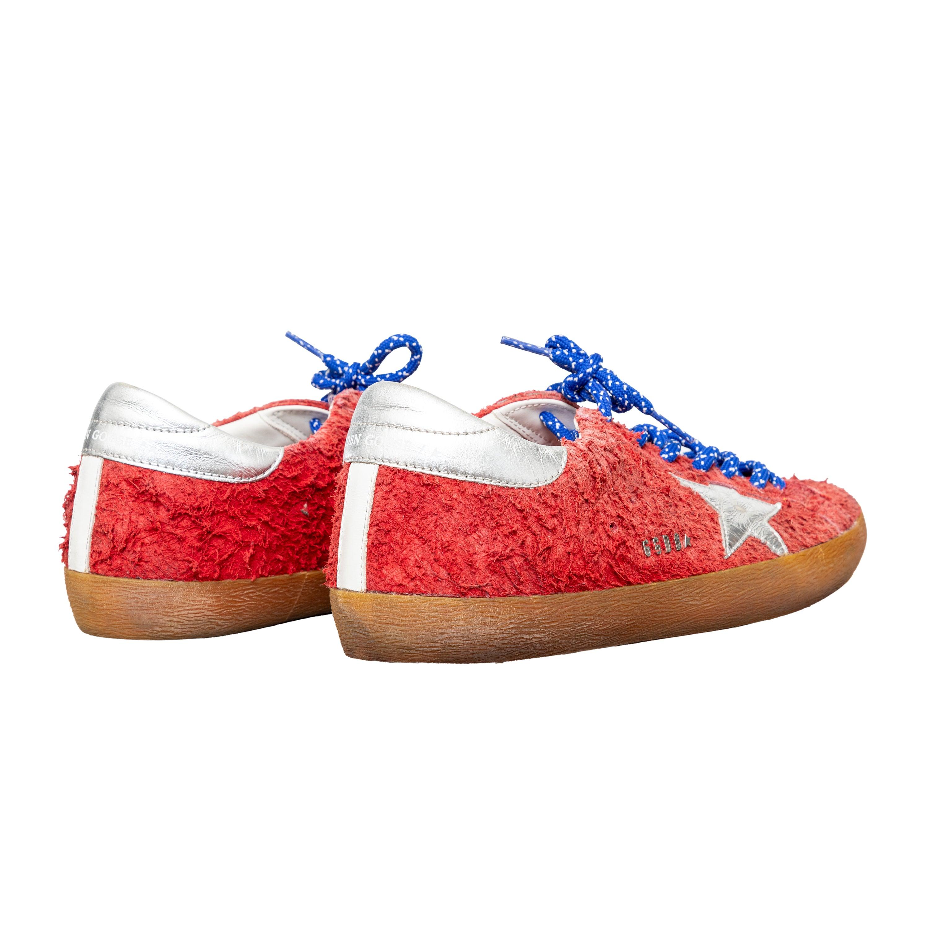 Soft red suede sneakers with a furry effect, silver trims, star accents, and blue lace-up in a low top design for an eye-catching look.
 Remarks: there are some imperfections. 
 Measurement: Insole Length:28.5;Heel:2.5 
 Material: Suede