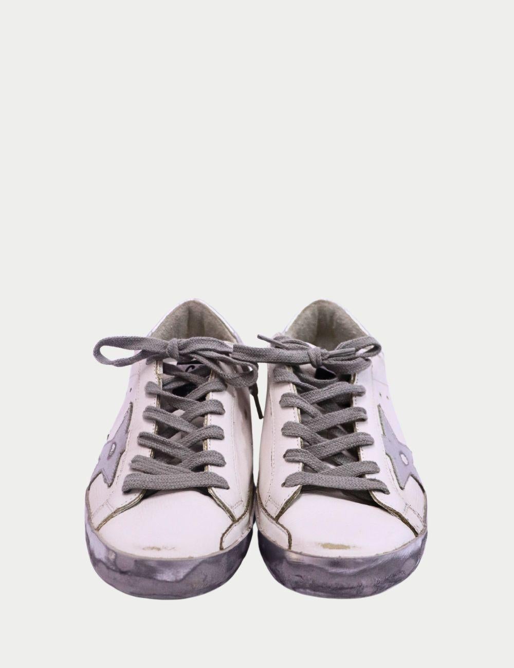 Golden Goose Superstar White Leather Sneakers with Silver Star – Women’s Designer Shoes


Add a dose of laid-back Italian luxury to your everyday look with these Golden Goose Superstar white leather sneakers, featuring the brand’s signature